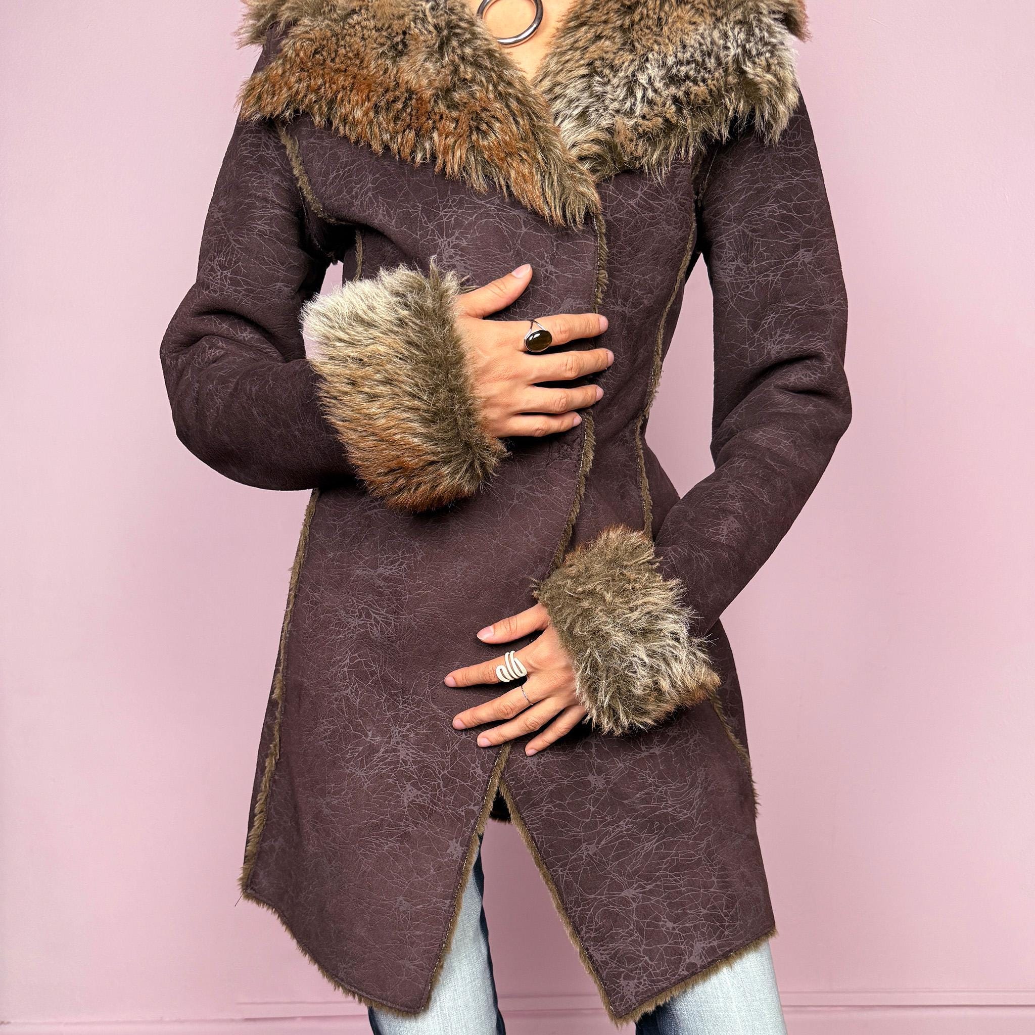 Vintage 2000s brown long coat in a statement penny lane style with a fitted silhouette. Features snap button closure, matching fabric belt, and plush brown and beige faux fur lining at the collar and cuffs. Perfect for city girl winter and Y2K styling. Made from a polyester acrylic blend. Excellent vintage condition.