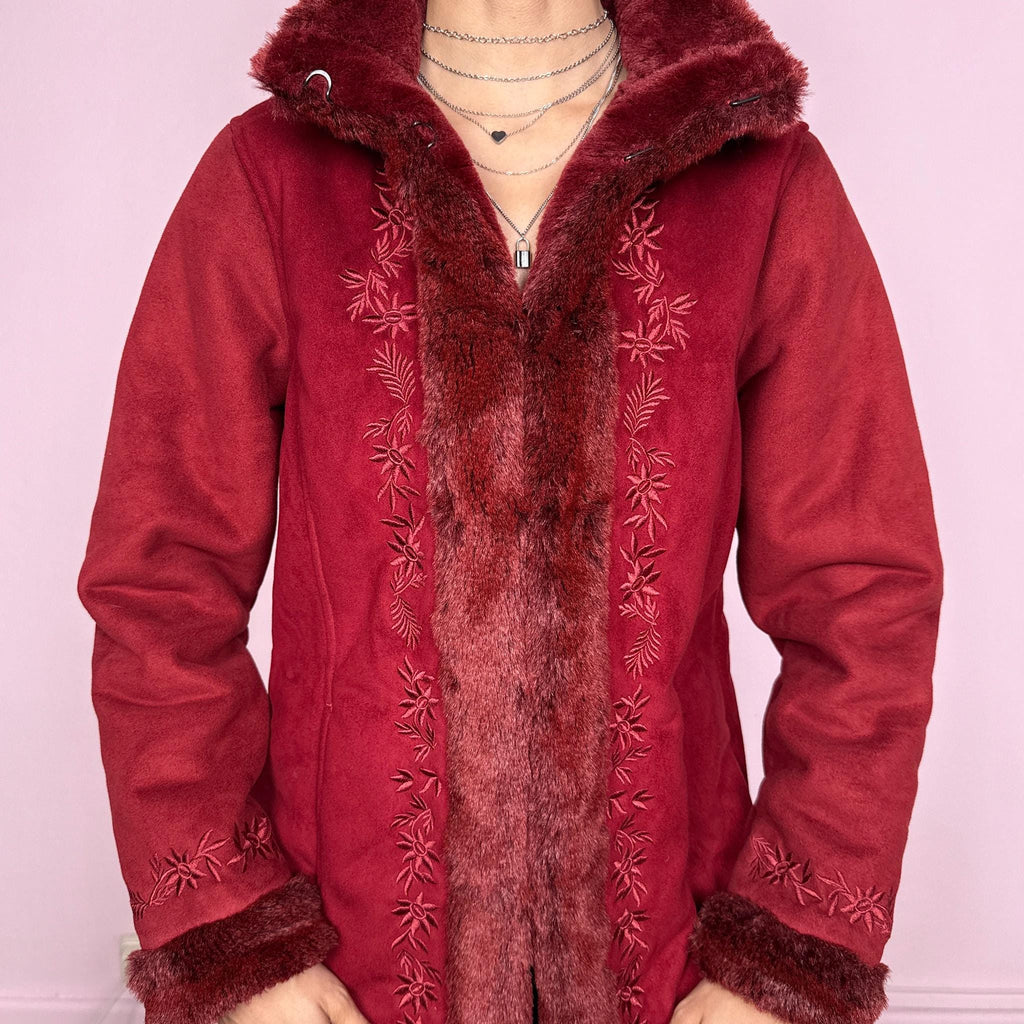 Vintage 2000s Penny Lane style coat in a deep red tone featuring rich embroidery and plush faux fur trim at the collar, cuffs, and interior. Designed with a cozy structured fit, pockets, and hook closure for a bold bohemian statement. Perfect for winter with a soft fairycore feel. Made from a polyester acrylic blend. Excellent vintage condition.