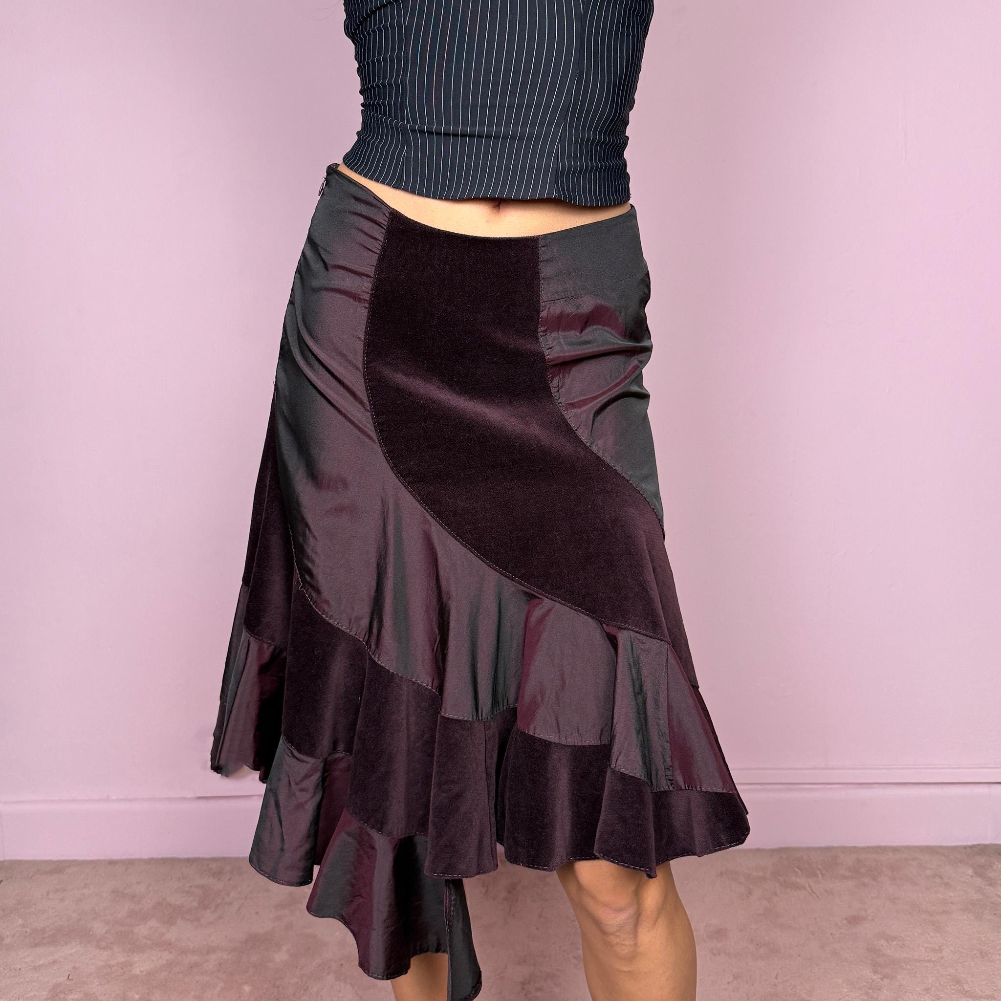 Elegant vintage 2000s burgundy midi skirt with a unique avant-garde design. Features curved velvet paneling, satin panels, and an asymmetric ruffled hem that creates beautiful movement. Side zip closure with slight stretch. Can be worn high waisted for size S or mid rise for size XS. Perfect for formal or party looks. Made in Italy by an Italian brand, 95% cotton. Excellent vintage condition.