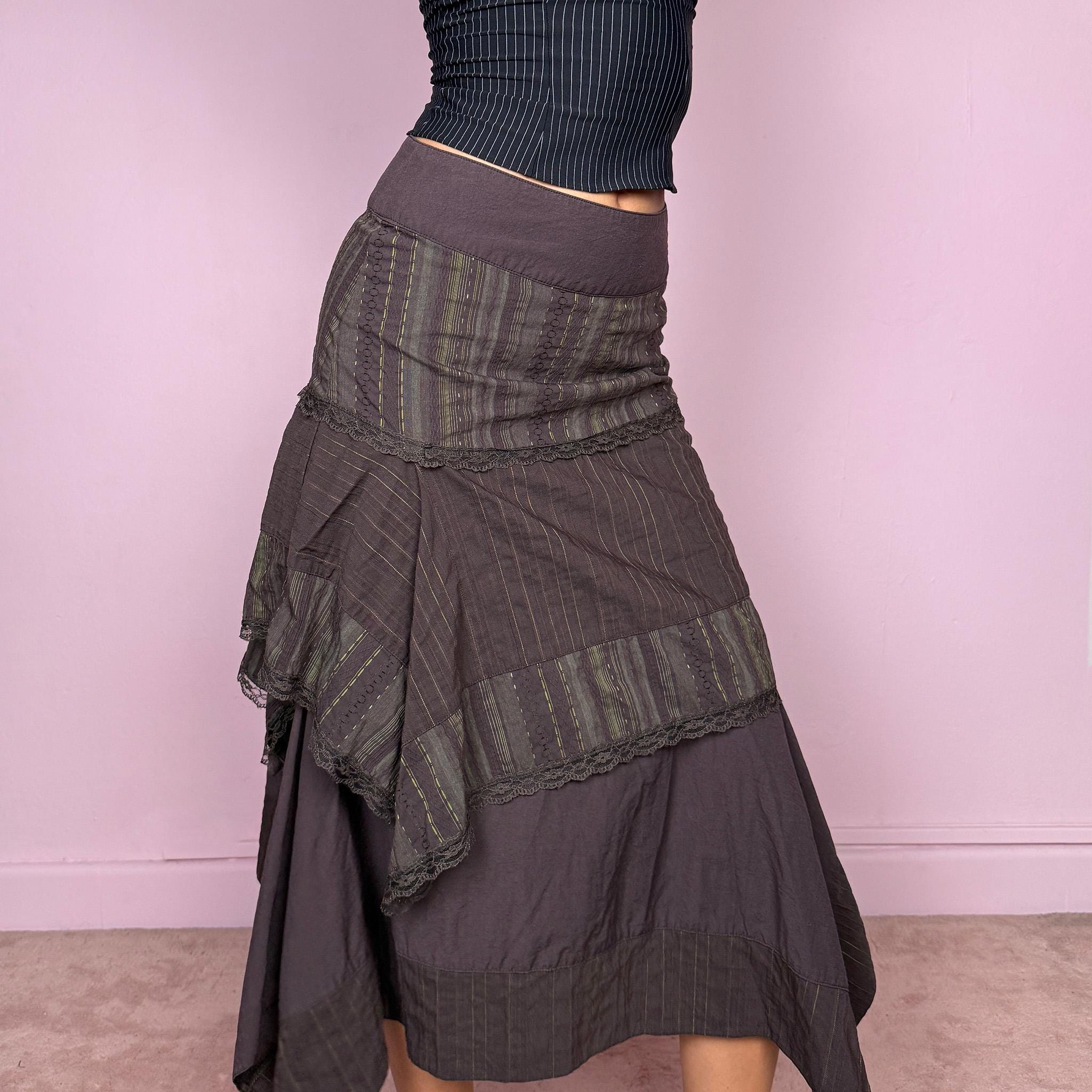 Vintage 2000s dark brown asymmetric midi skirt with an avant garde deconstructed layered design, featuring striped panels with subtle green lines, lace trim, and tie drawstring side details. Side zipper closure with no stretch. Fairy grunge aesthetic. Can be worn high waisted for size S or worn lower on the waist for size XS/XXS. Made by a French brand from a cotton polyester polyamide blend. Great vintage condition.