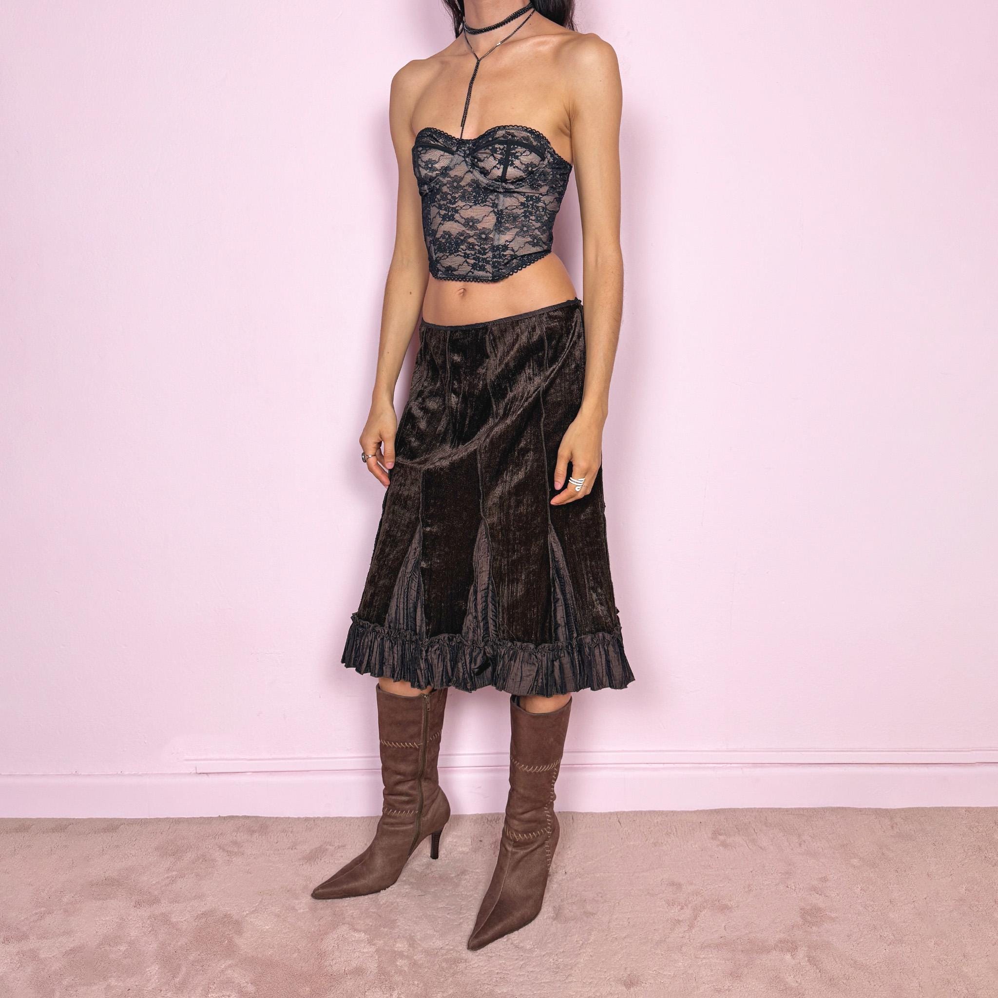 Vintage 90s dark brown velvet midi skirt with a whimsical fairycore feel. Features soft godet inserts creating a flared silhouette and a ruffle hem for movement. Back zip closure with slight stretch. Can be worn high waisted for size L or low rise for size M. Perfect for autumn winter avant garde styling. Great vintage condition.