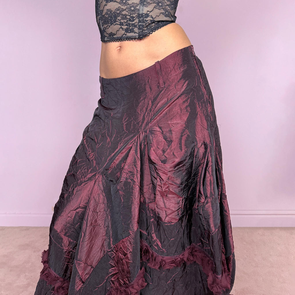 Vintage 2000s burgundy iridescent midi skirt with an avant garde experimental feel. Features a crinkle texture, asymmetric hem, and sculptural draped panels with rosette appliqué details. Voluminous and artistic silhouette with back zip closure, no stretch. Can be worn high waisted for size M or lower for XS/S. Made from polyester. Rare archive piece. Excellent vintage condition.
