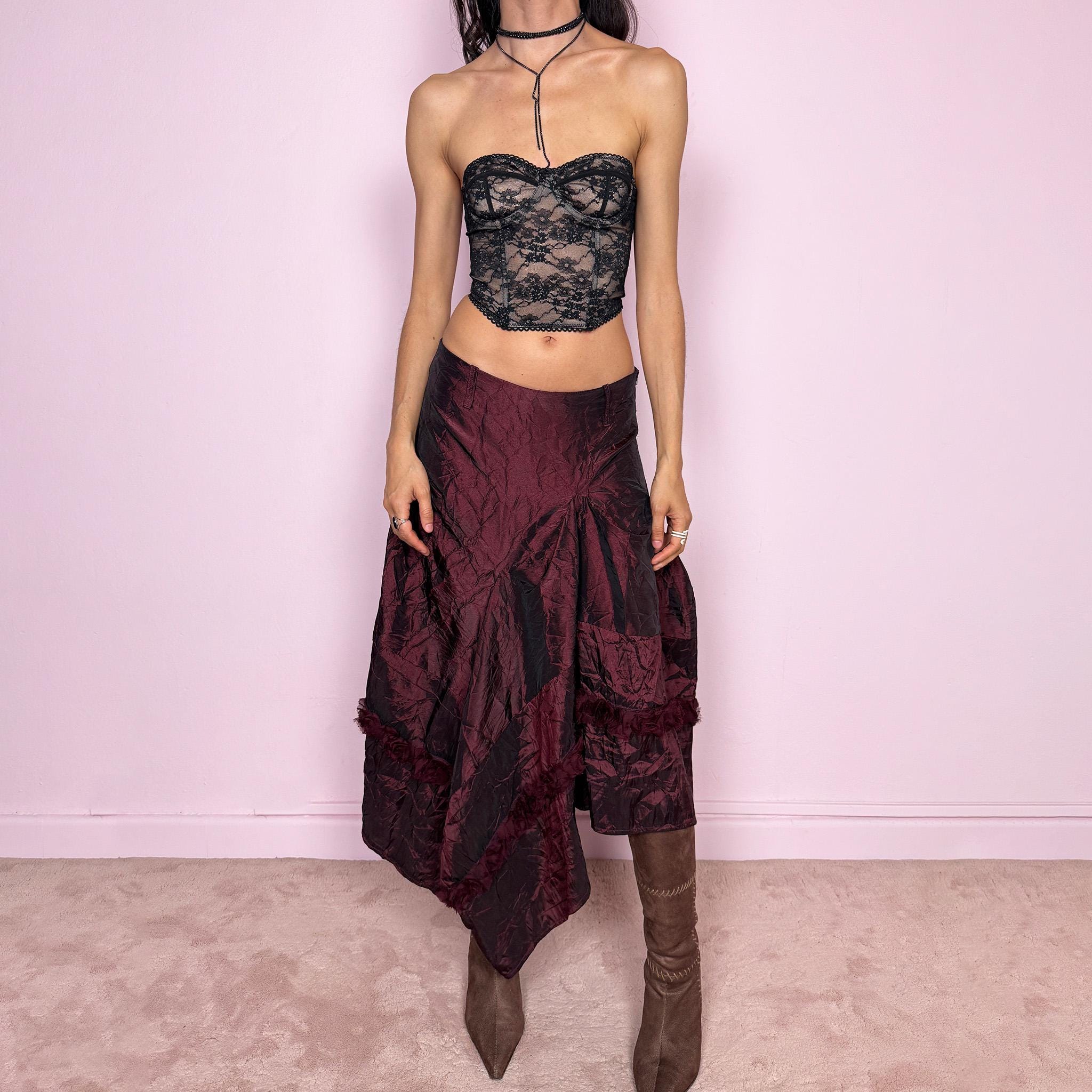 Vintage 2000s burgundy iridescent midi skirt with an avant garde experimental feel. Features a crinkle texture, asymmetric hem, and sculptural draped panels with rosette appliqué details. Voluminous and artistic silhouette with back zip closure, no stretch. Can be worn high waisted for size M or lower for XS/S. Made from polyester. Rare archive piece. Excellent vintage condition.