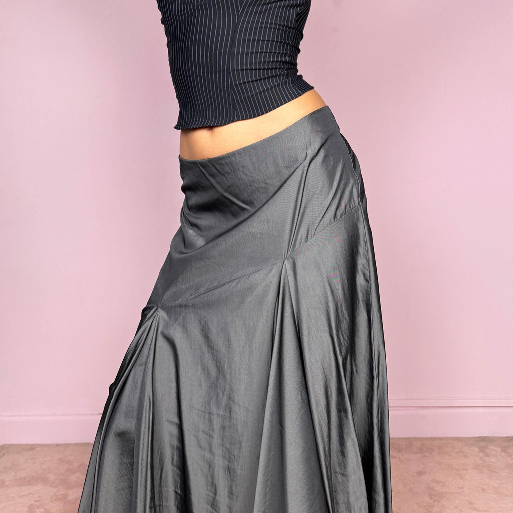 Vintage 2000s silver gray midi skirt with an avant garde asymmetric deconstructed design and fluid godet panel details. Features a glossy satin-like finish, no stretch structure, and back zip closure. Can be worn low rise for size S or mid rise for size M. Perfect for formal, statement, or evening wear. Made from a polyester viscose blend. Excellent vintage condition.