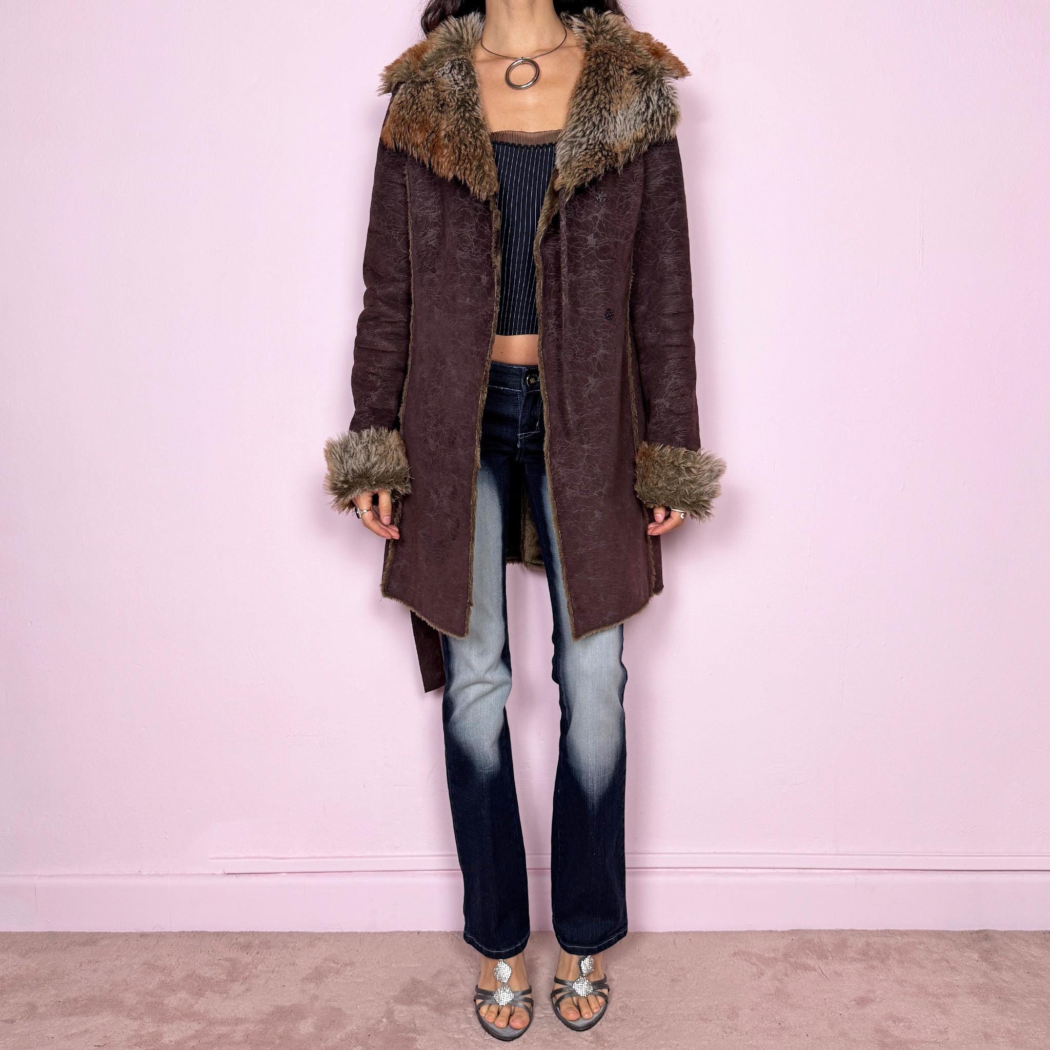 Vintage 2000s brown long coat in a statement penny lane style with a fitted silhouette. Features snap button closure, matching fabric belt, and plush brown and beige faux fur lining at the collar and cuffs. Perfect for city girl winter and Y2K styling. Made from a polyester acrylic blend. Excellent vintage condition.