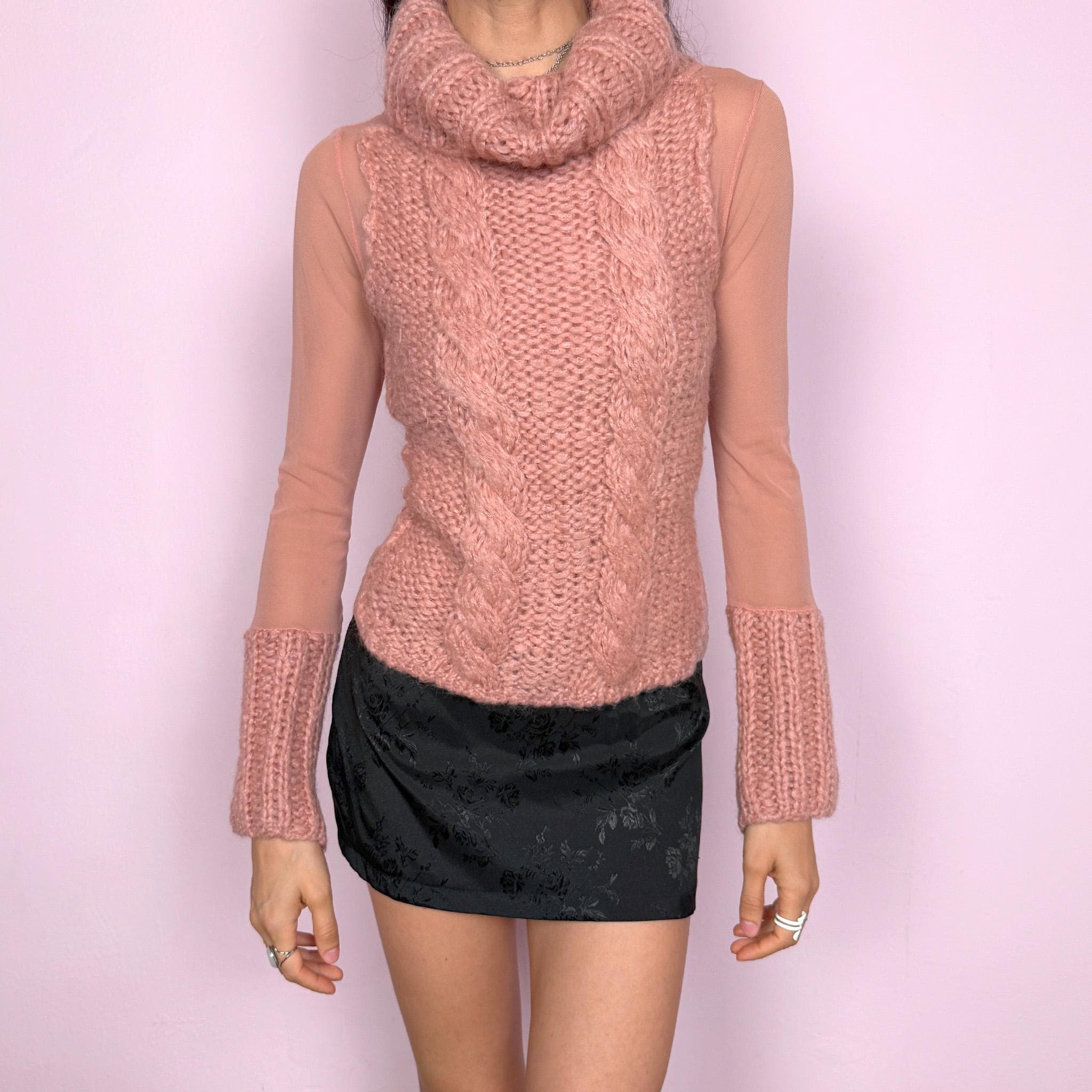 Vintage 2000s avant garde bi-material pink top with a turtleneck, cuffs, and cable knit front crafted from 40% mohair, 30% wool, and 20% acrylic, combined with semi sheer mesh polyamide panels. Stretchy with a fitted silhouette, blending soft coquette aesthetics with a unique deconstructed design. Made in Italy. Excellent vintage condition.