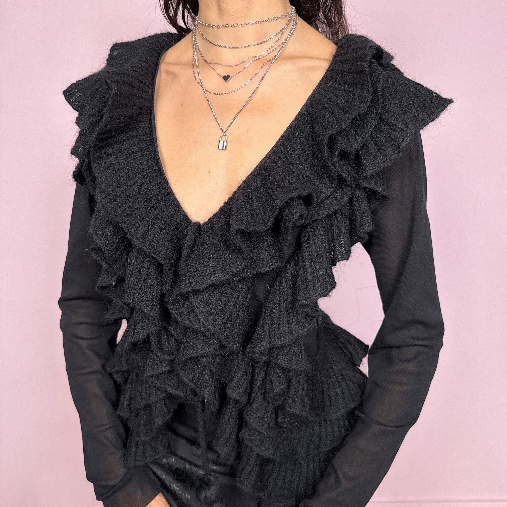 Vintage 2000s avant garde black mesh long sleeve tie front top featuring cascading knit ruffles over a sheer polyamide base, creating a dark romantic silhouette with soft texture and fluid movement. Ruffles are crafted from 30% kid mohair with a polyamide acrylic blend. Ideal for evening, night, party, or statement layering. Made in Italy by a French brand. Excellent vintage condition.