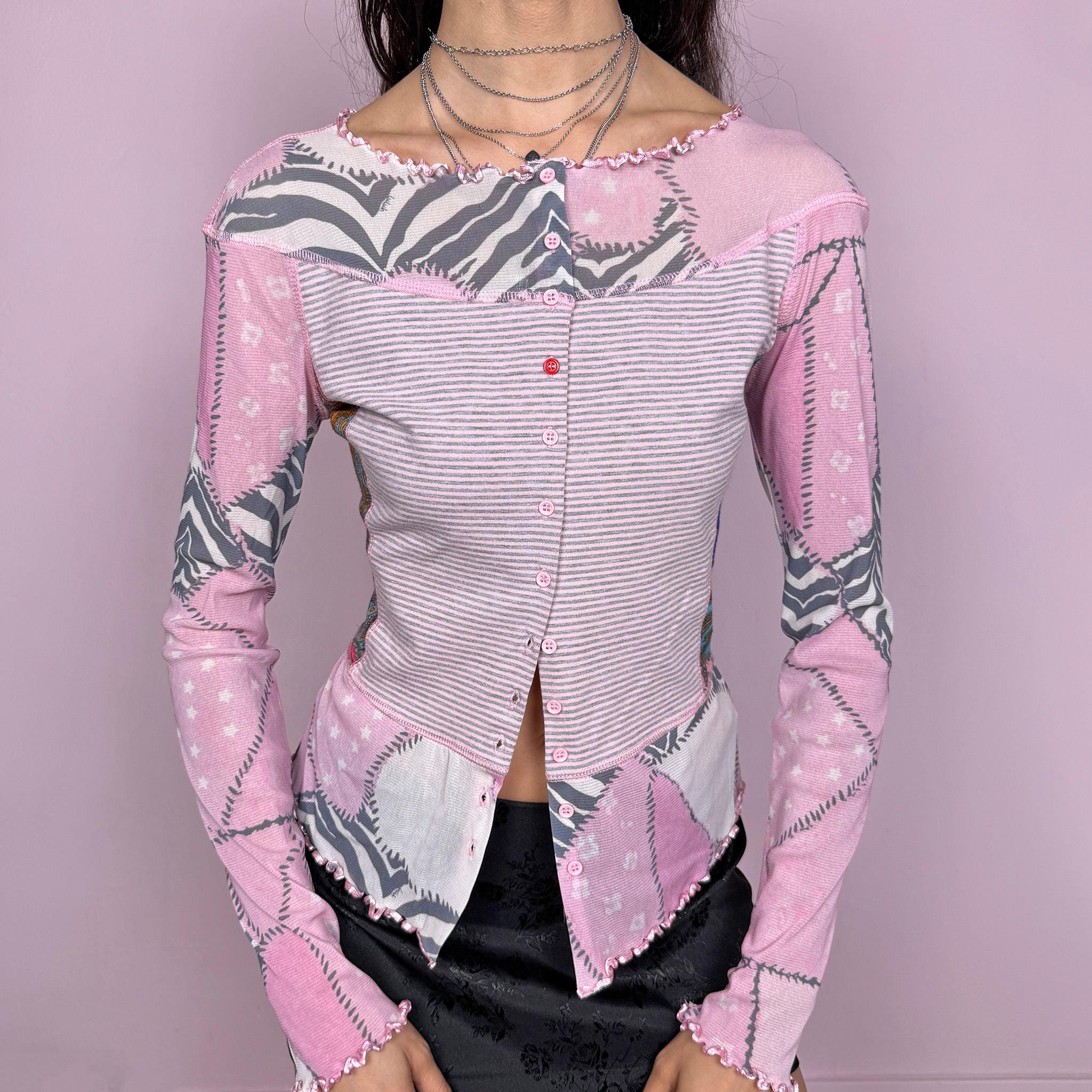 Vintage 2000s pink coquette style long sleeve stretchy fitted top with mesh panels and sleeves featuring an abstract print, and a striped front with button closure. Finished with a lettuce hem for a soft feminine look. Perfect for spring or summer layering. Made by a French brand. Excellent vintage condition.
