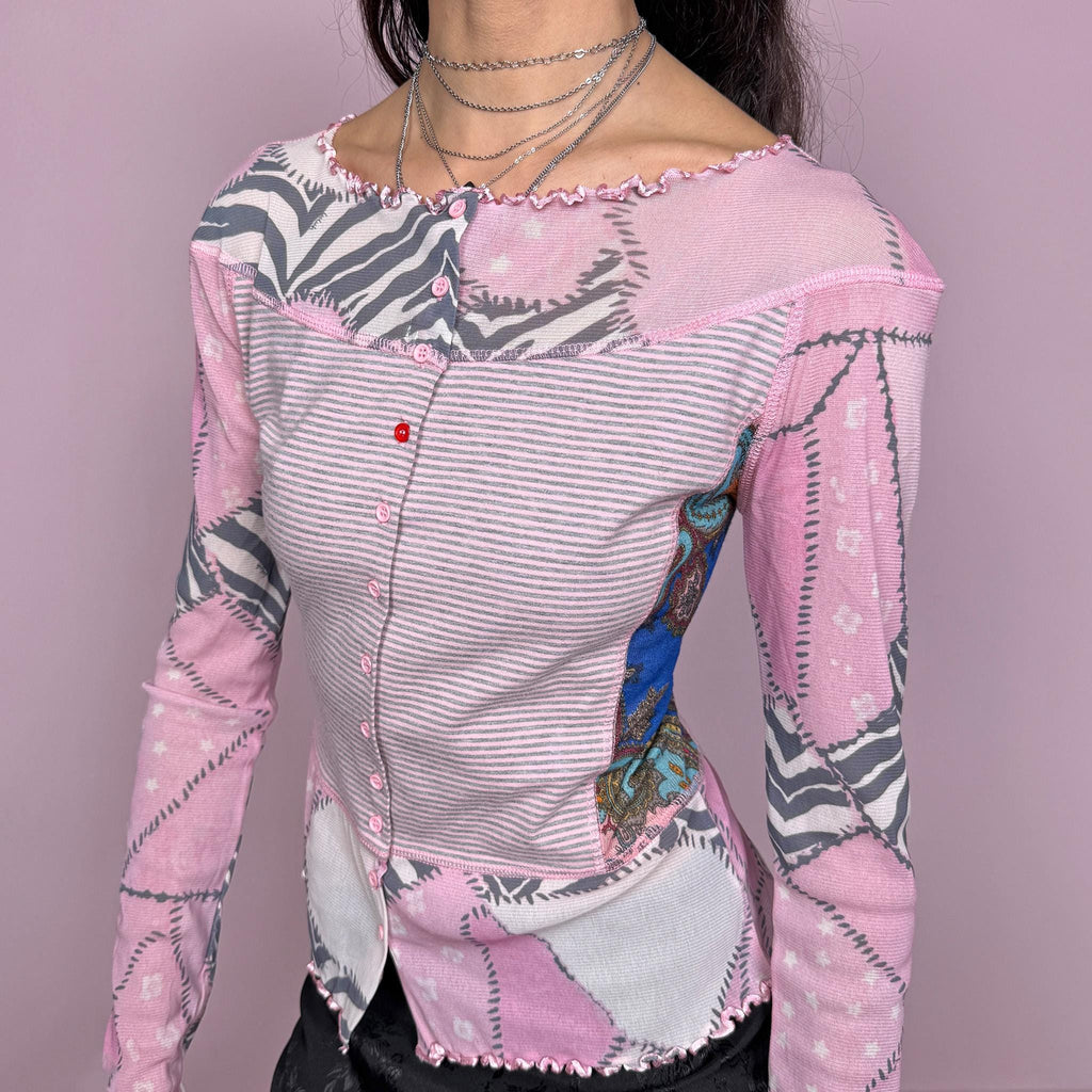 Vintage 2000s pink coquette style long sleeve stretchy fitted top with mesh panels and sleeves featuring an abstract print, and a striped front with button closure. Finished with a lettuce hem for a soft feminine look. Perfect for spring or summer layering. Made by a French brand. Excellent vintage condition.