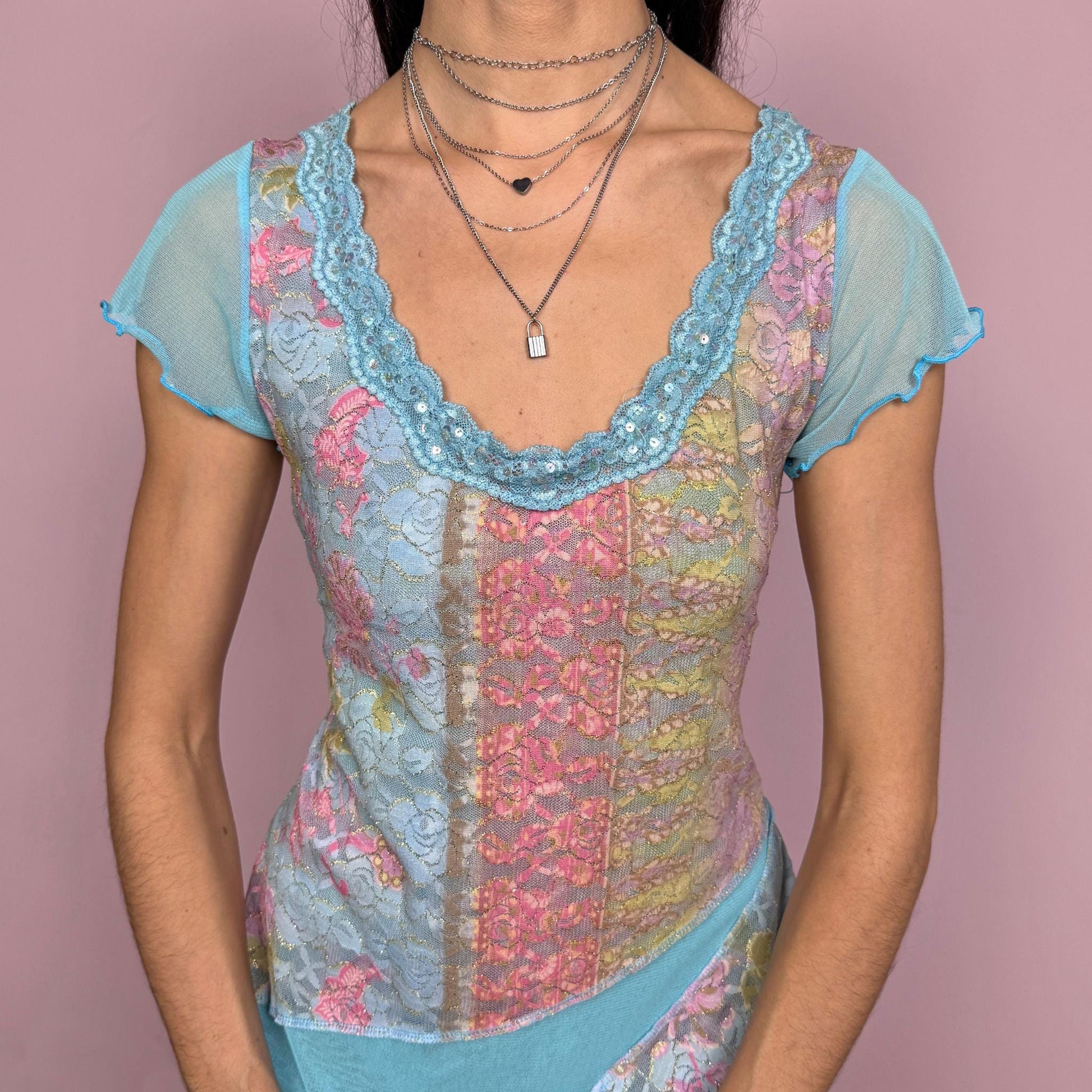 Vintage 2000s stunning unique blue short sleeve mesh top with an asymmetric slit hem, lace trim at the neckline with sequin details, and multicolored lace panels. Stretchy with a fitted yet flowy silhouette, creating an ethereal fairycore feel. Perfect for summer or party wear. Made in France by a French brand from a polyamide blend. Excellent vintage condition.