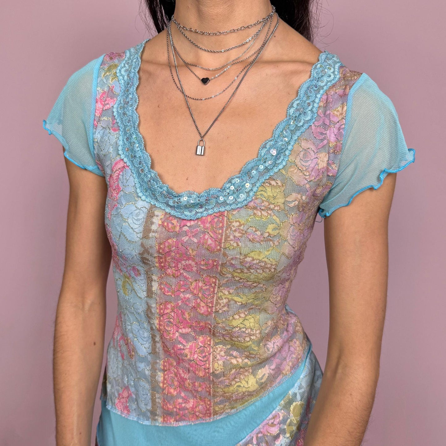 Vintage 2000s stunning unique blue short sleeve mesh top with an asymmetric slit hem, lace trim at the neckline with sequin details, and multicolored lace panels. Stretchy with a fitted yet flowy silhouette, creating an ethereal fairycore feel. Perfect for summer or party wear. Made in France by a French brand from a polyamide blend. Excellent vintage condition.