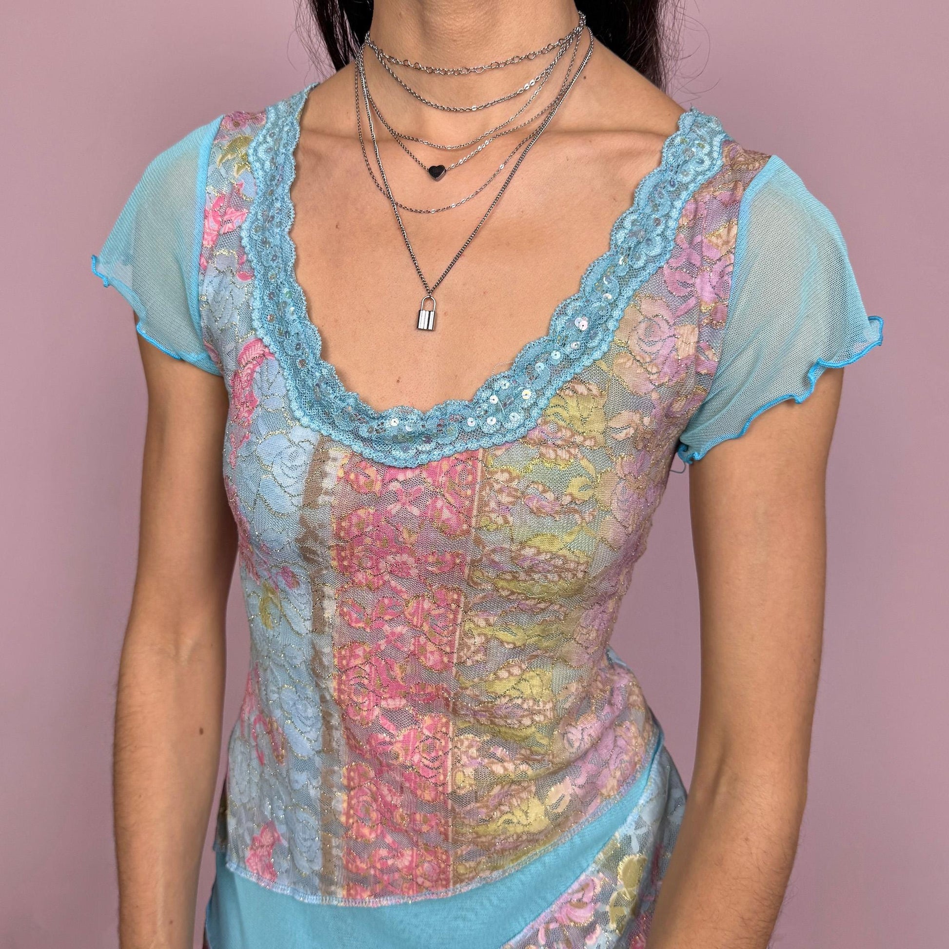Vintage 2000s stunning unique blue short sleeve mesh top with an asymmetric slit hem, lace trim at the neckline with sequin details, and multicolored lace panels. Stretchy with a fitted yet flowy silhouette, creating an ethereal fairycore feel. Perfect for summer or party wear. Made in France by a French brand from a polyamide blend. Excellent vintage condition.
