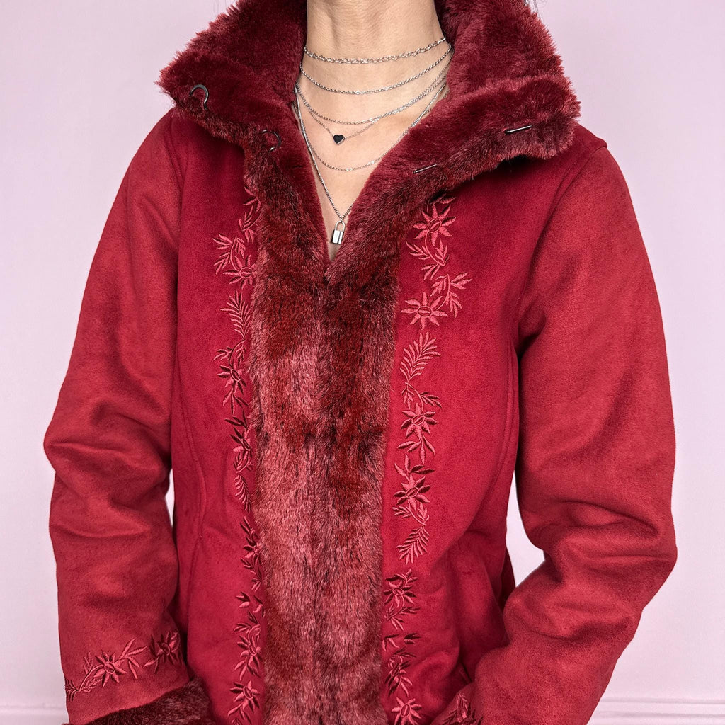 Vintage 2000s Penny Lane style coat in a deep red tone featuring rich embroidery and plush faux fur trim at the collar, cuffs, and interior. Designed with a cozy structured fit, pockets, and hook closure for a bold bohemian statement. Perfect for winter with a soft fairycore feel. Made from a polyester acrylic blend. Excellent vintage condition.