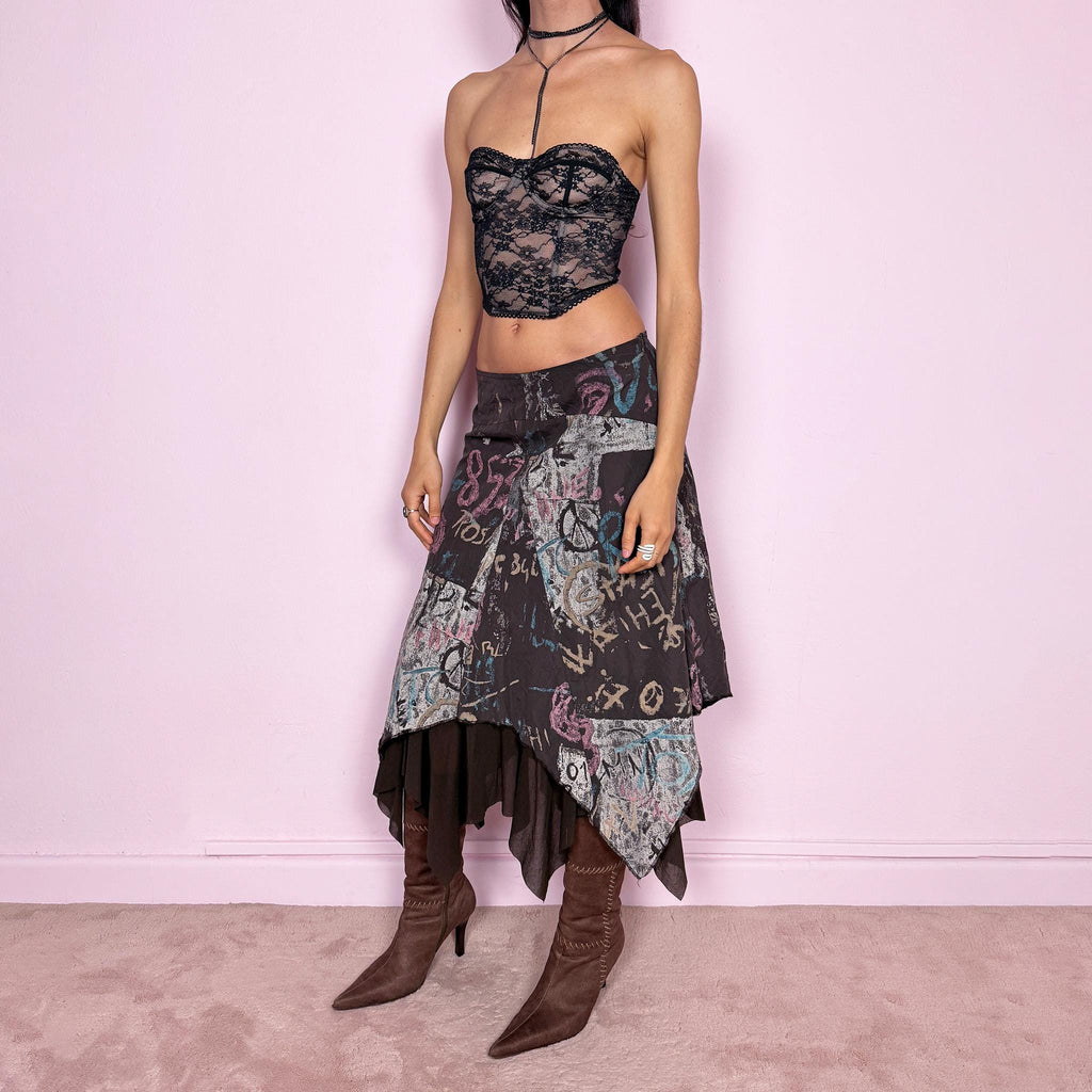 Vintage 2000s brown deconstructed avant garde skirt with a layered asymmetric hem and sheer mesh underlayer. Features a fluid draped silhouette with graphic print and side zip closure, no stretch. Can be worn high rise for size M or mid to low rise for XS/S. Made in France by a French brand from polyamide. Excellent vintage condition.