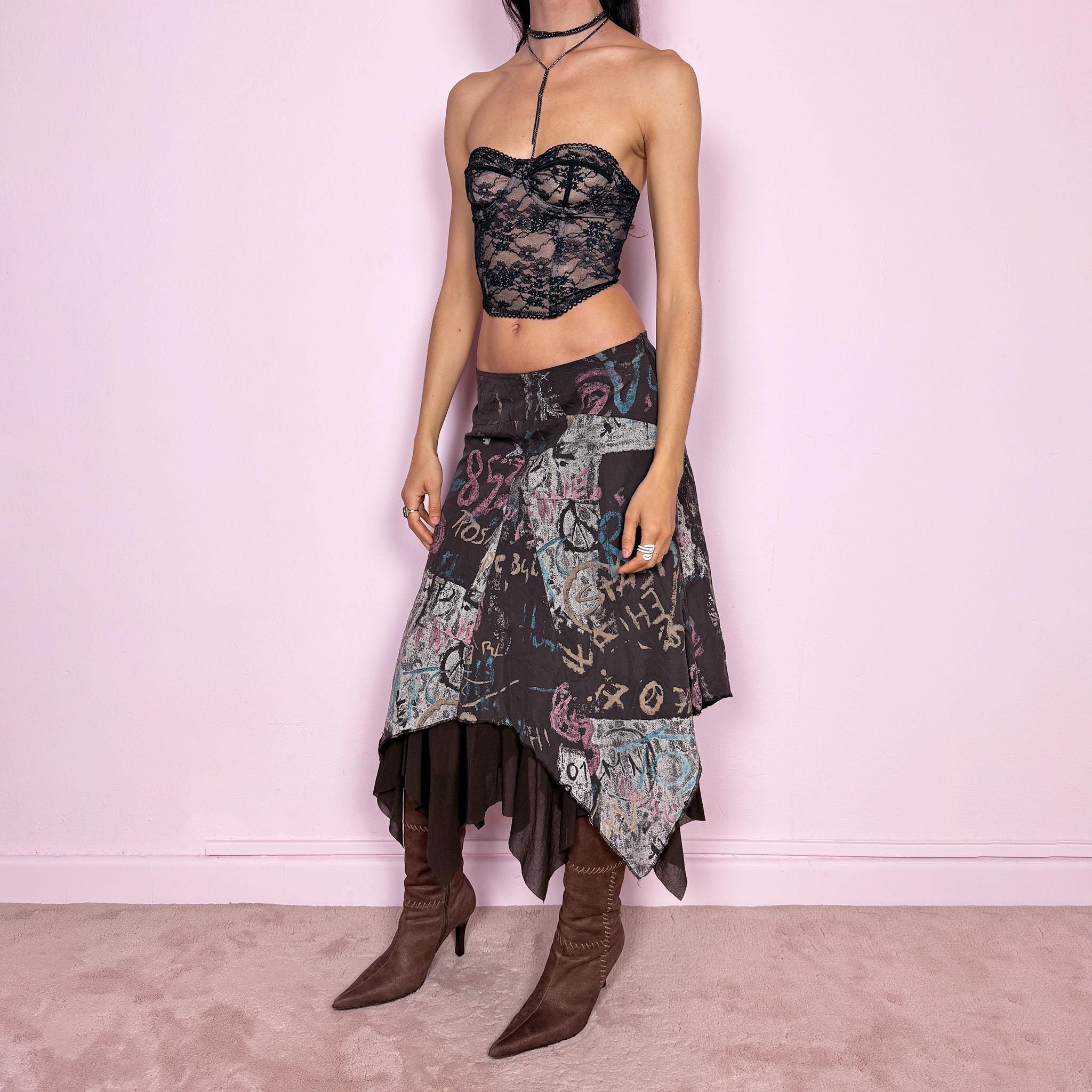 Vintage 2000s brown deconstructed avant garde skirt with a layered asymmetric hem and sheer mesh underlayer. Features a fluid draped silhouette with graphic print and side zip closure, no stretch. Can be worn high rise for size M or mid to low rise for XS/S. Made in France by a French brand from polyamide. Excellent vintage condition.