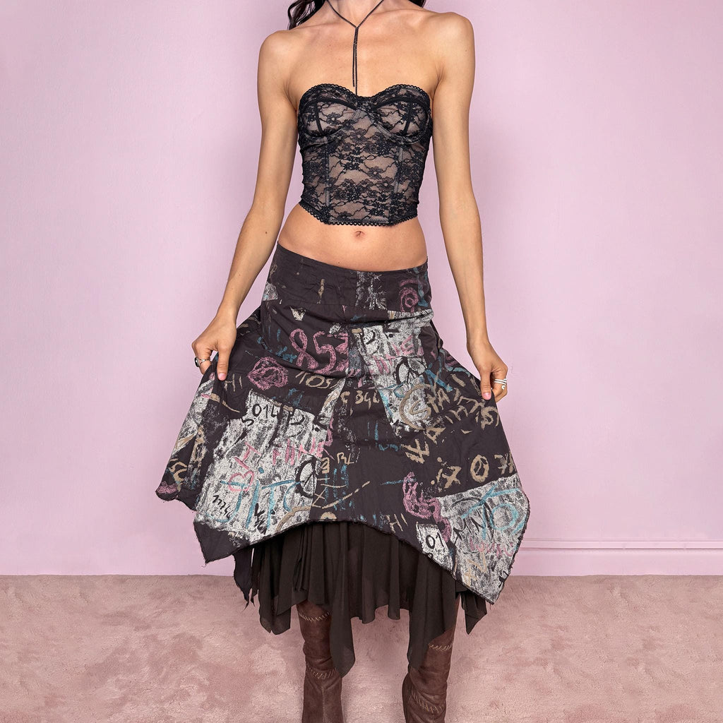Vintage 2000s brown deconstructed avant garde skirt with a layered asymmetric hem and sheer mesh underlayer. Features a fluid draped silhouette with graphic print and side zip closure, no stretch. Can be worn high rise for size M or mid to low rise for XS/S. Made in France by a French brand from polyamide. Excellent vintage condition.