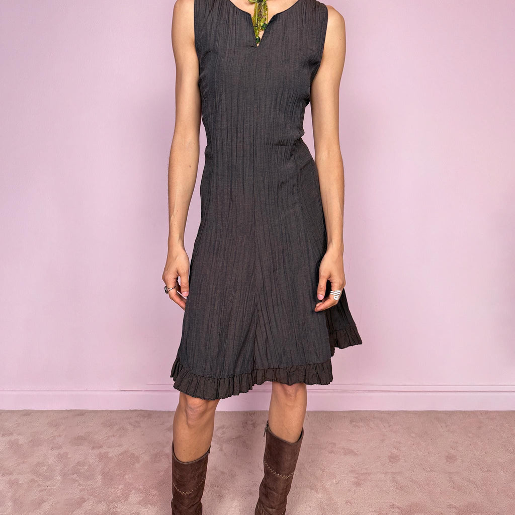 Vintage 2000s dark brown sleeveless midi dress with a crinkle texture and sleek fitted silhouette. Features a soft ruffle hem and back zip closure with a non-stretch fit. Moody avant-garde fairy styling, perfect for spring summer wear, effortless daytime looks, or elevated evening dressing. Made in France by a French brand. Great vintage condition.