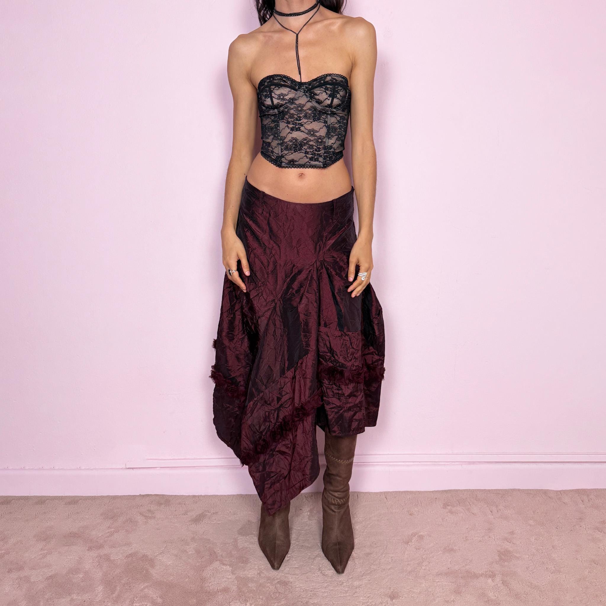 Vintage 2000s burgundy iridescent midi skirt with an avant garde experimental feel. Features a crinkle texture, asymmetric hem, and sculptural draped panels with rosette appliqué details. Voluminous and artistic silhouette with back zip closure, no stretch. Can be worn high waisted for size M or lower for XS/S. Made from polyester. Rare archive piece. Excellent vintage condition.