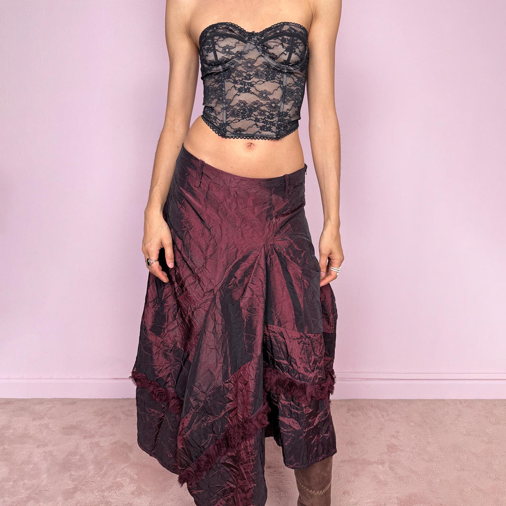 Vintage 2000s burgundy iridescent midi skirt with an avant garde experimental feel. Features a crinkle texture, asymmetric hem, and sculptural draped panels with rosette appliqué details. Voluminous and artistic silhouette with back zip closure, no stretch. Can be worn high waisted for size M or lower for XS/S. Made from polyester. Rare archive piece. Excellent vintage condition.