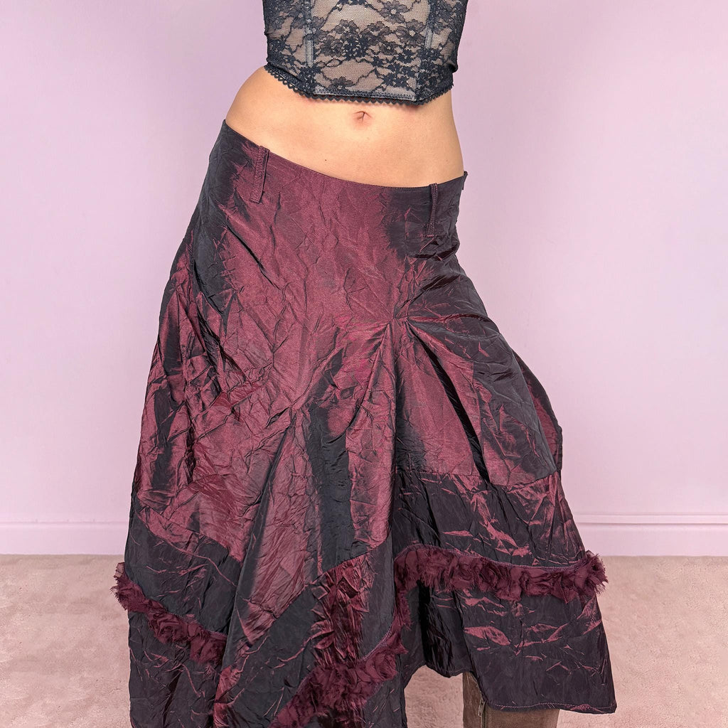 Vintage 2000s burgundy iridescent midi skirt with an avant garde experimental feel. Features a crinkle texture, asymmetric hem, and sculptural draped panels with rosette appliqué details. Voluminous and artistic silhouette with back zip closure, no stretch. Can be worn high waisted for size M or lower for XS/S. Made from polyester. Rare archive piece. Excellent vintage condition.