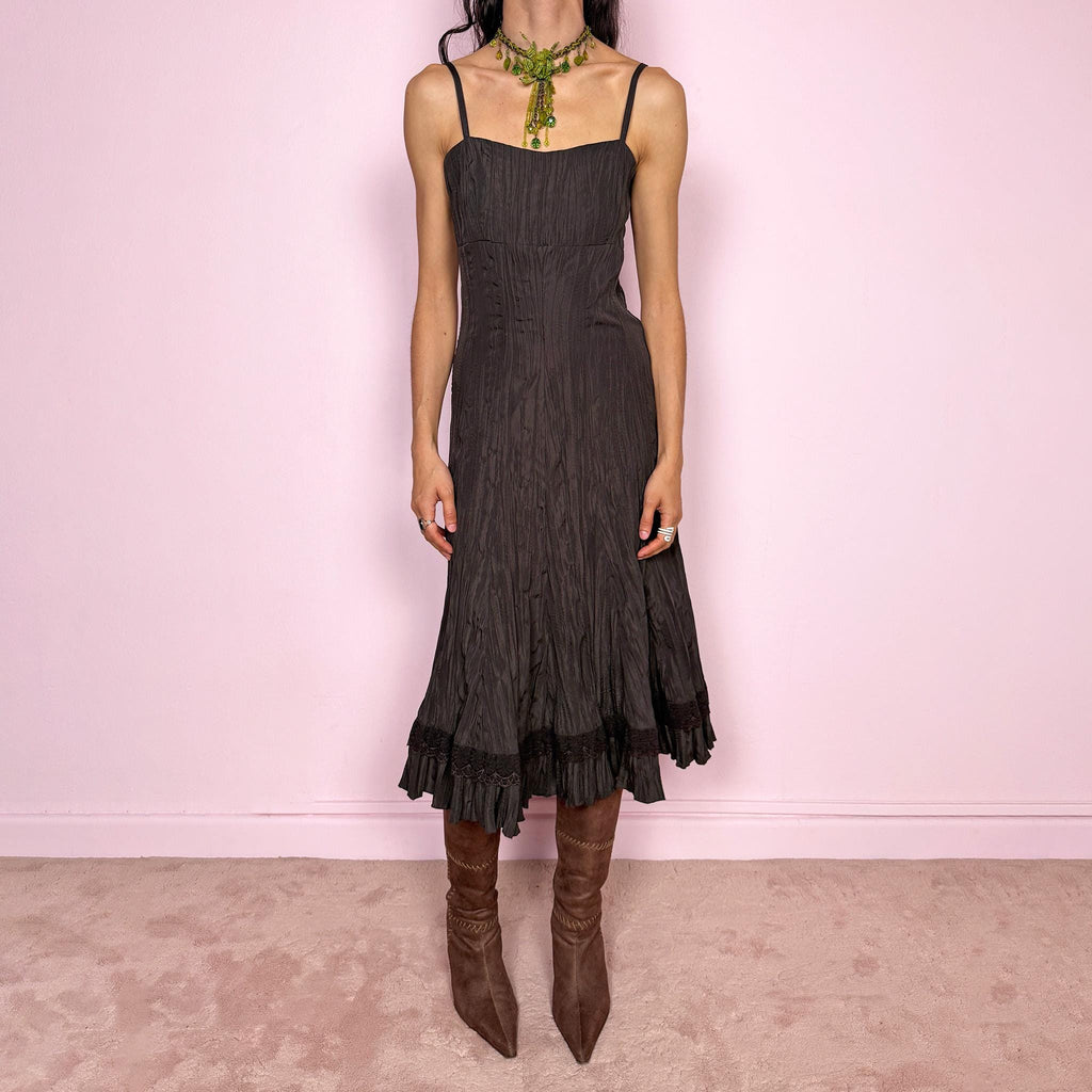 Vintage 2000s dark brown midi dress with a crinkle pleated texture and sleek fitted silhouette. Features adjustable straps, side zip closure, and a soft ruffle hem for fluid movement. Non-stretch design with minimal avant-garde elegance, perfect for formal parties, night events, or dark fairy styling. Excellent vintage condition.