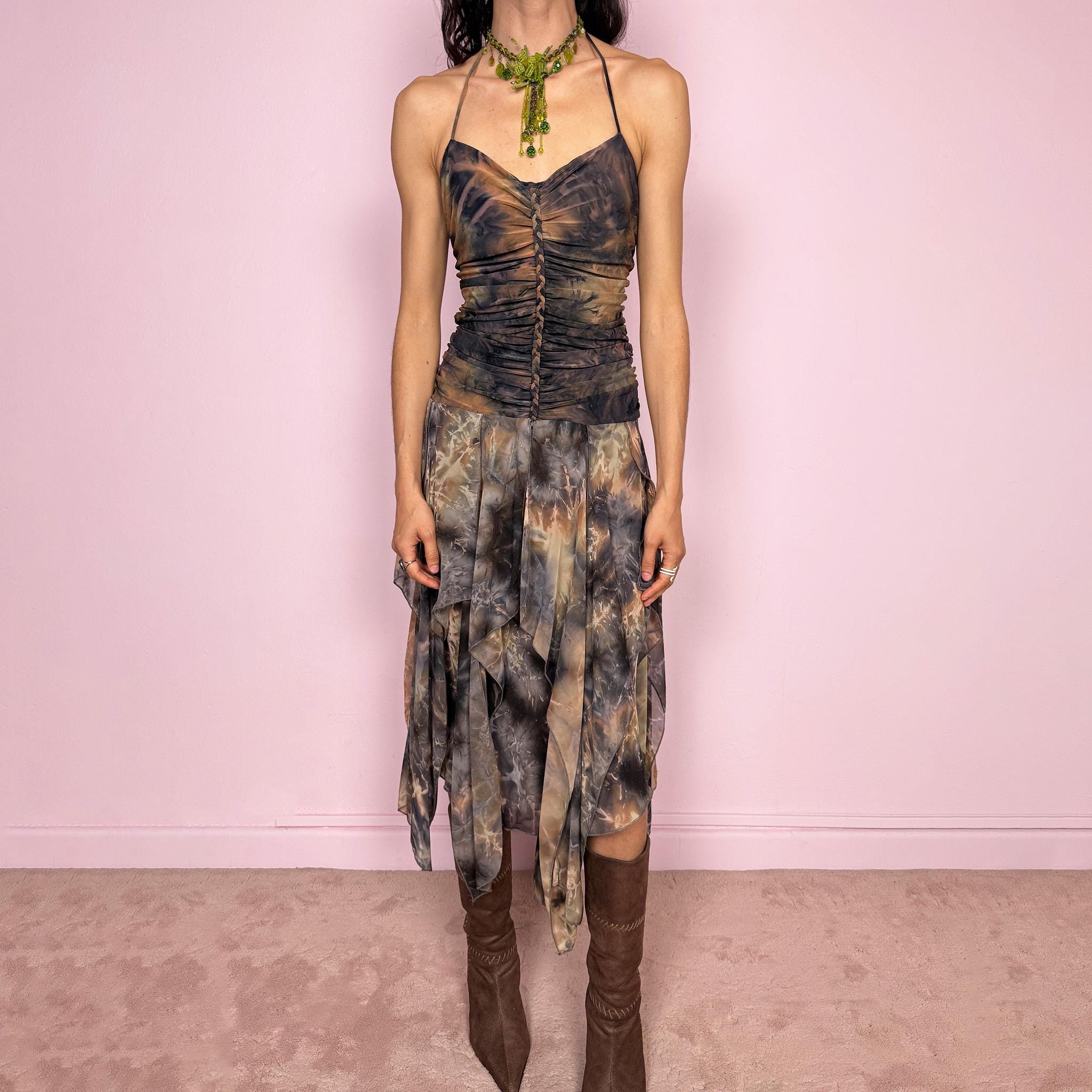 Vintage 2000s multicolored halter midi dress with a tie-neck design and ruched stretchy bodice for a flattering fitted silhouette. Features a dramatic asymmetric handkerchief hem and bold psychedelic tie-dye print in earthy tones. Stunning statement piece perfect for festivals, boho fairy styling, or summer events. Made in USA from polyester. Excellent vintage condition.