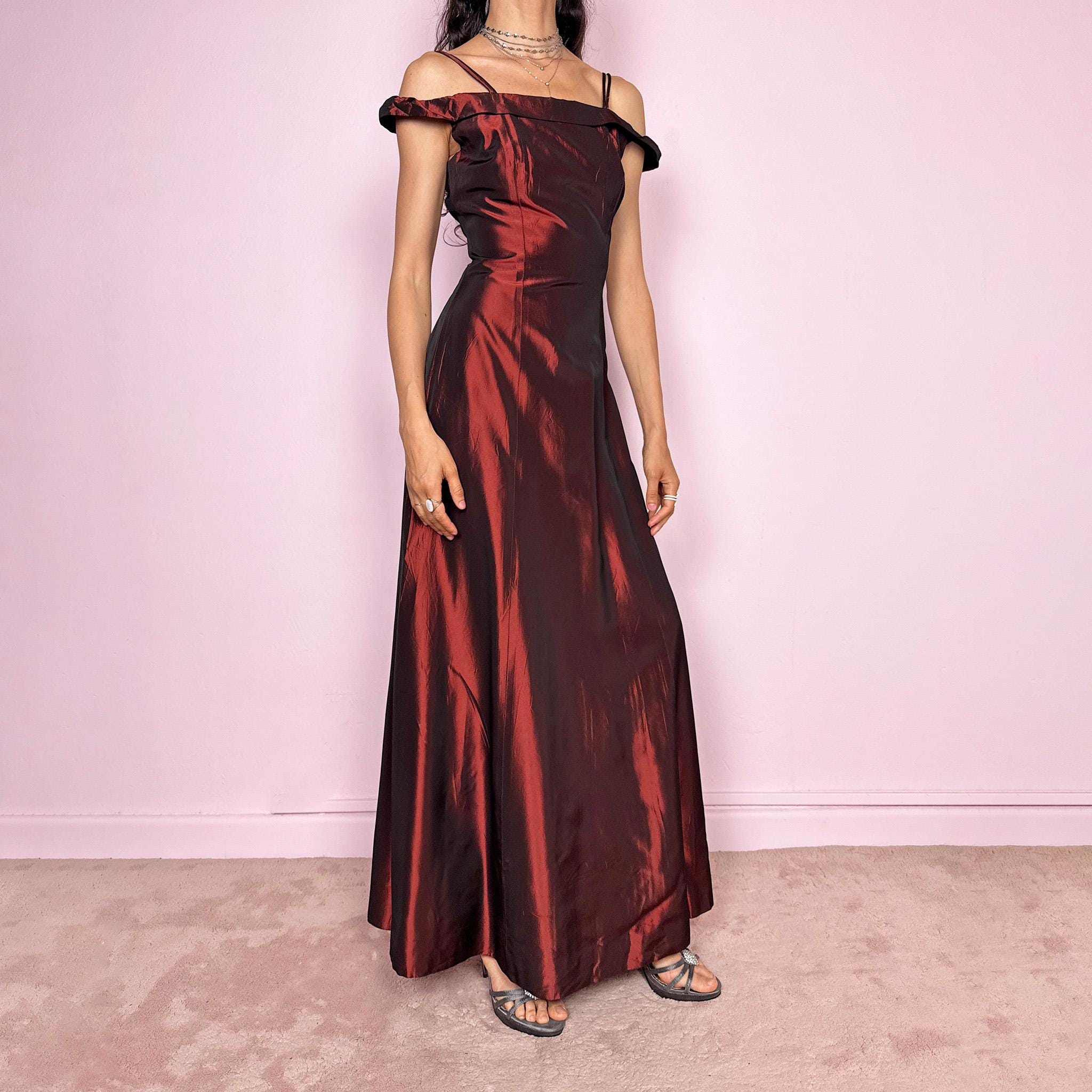 Vintage 2000s statement evening gown in rich burgundy iridescent fabric with a sculpted off shoulder neckline and delicate straps. Elegant body-skimming silhouette with full length maxi cut, subtle flare hem and back zip closure. Dramatic old Hollywood energy, perfect for formal events, editorials or modern occasionwear. Non-stretch fabric. Excellent vintage condition.