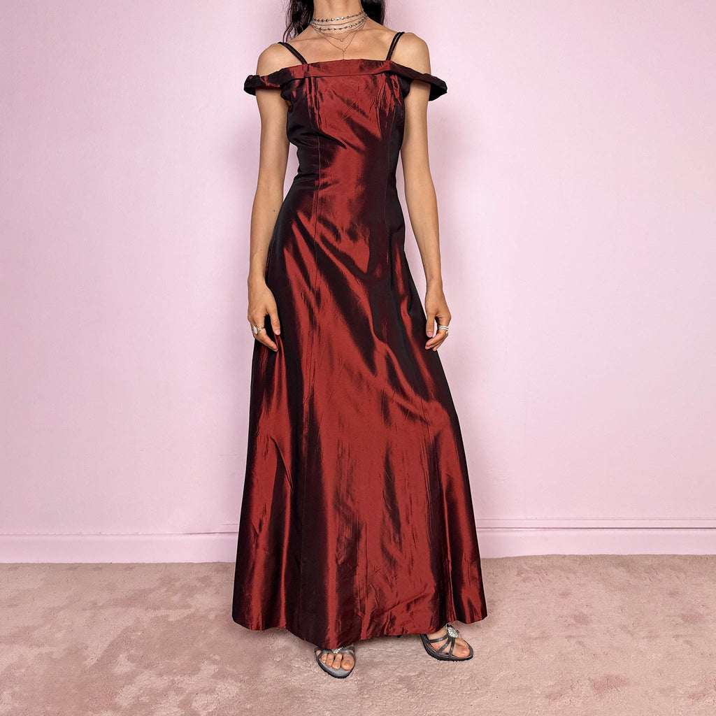 Vintage 2000s statement evening gown in rich burgundy iridescent fabric with a sculpted off shoulder neckline and delicate straps. Elegant body-skimming silhouette with full length maxi cut, subtle flare hem and back zip closure. Dramatic old Hollywood energy, perfect for formal events, editorials or modern occasionwear. Non-stretch fabric. Excellent vintage condition.