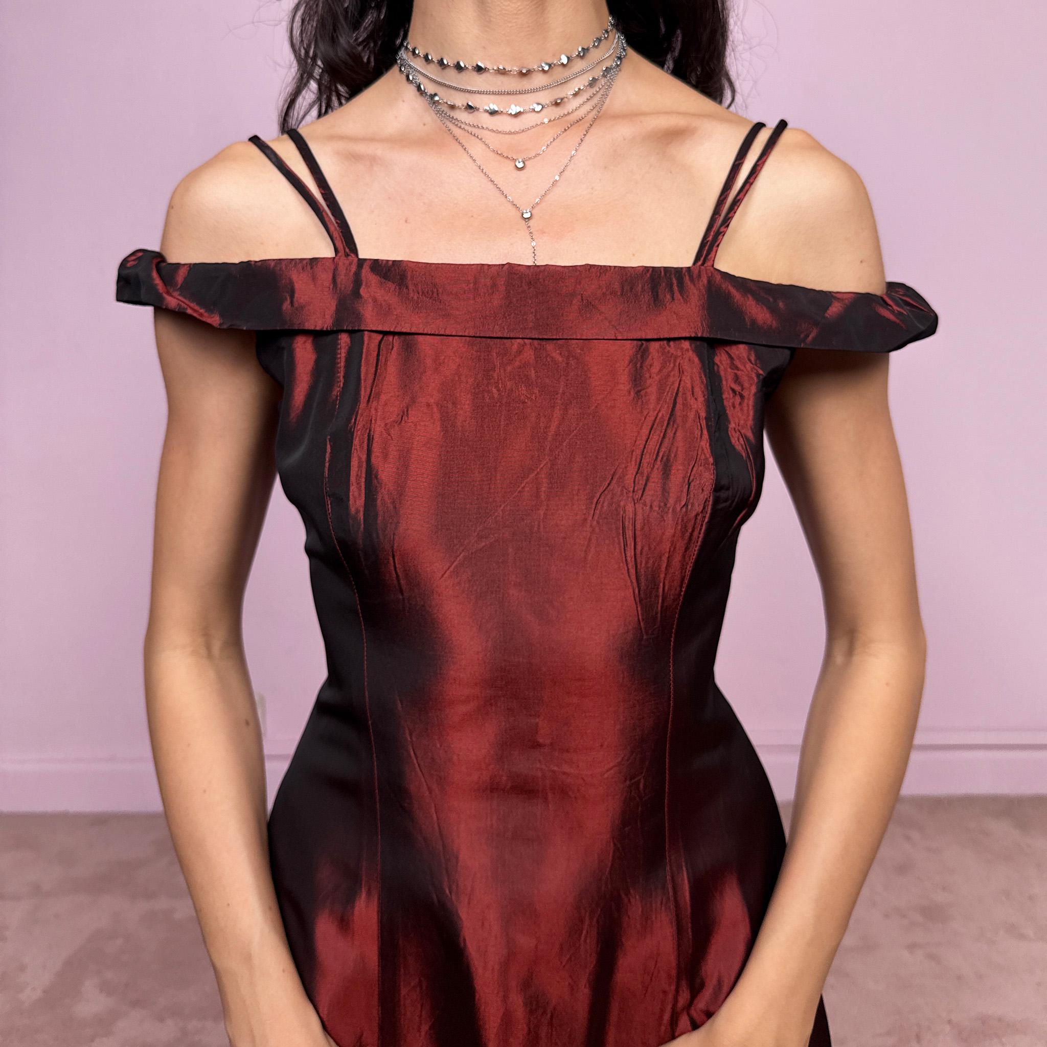 Vintage 2000s statement evening gown in rich burgundy iridescent fabric with a sculpted off shoulder neckline and delicate straps. Elegant body-skimming silhouette with full length maxi cut, subtle flare hem and back zip closure. Dramatic old Hollywood energy, perfect for formal events, editorials or modern occasionwear. Non-stretch fabric. Excellent vintage condition.