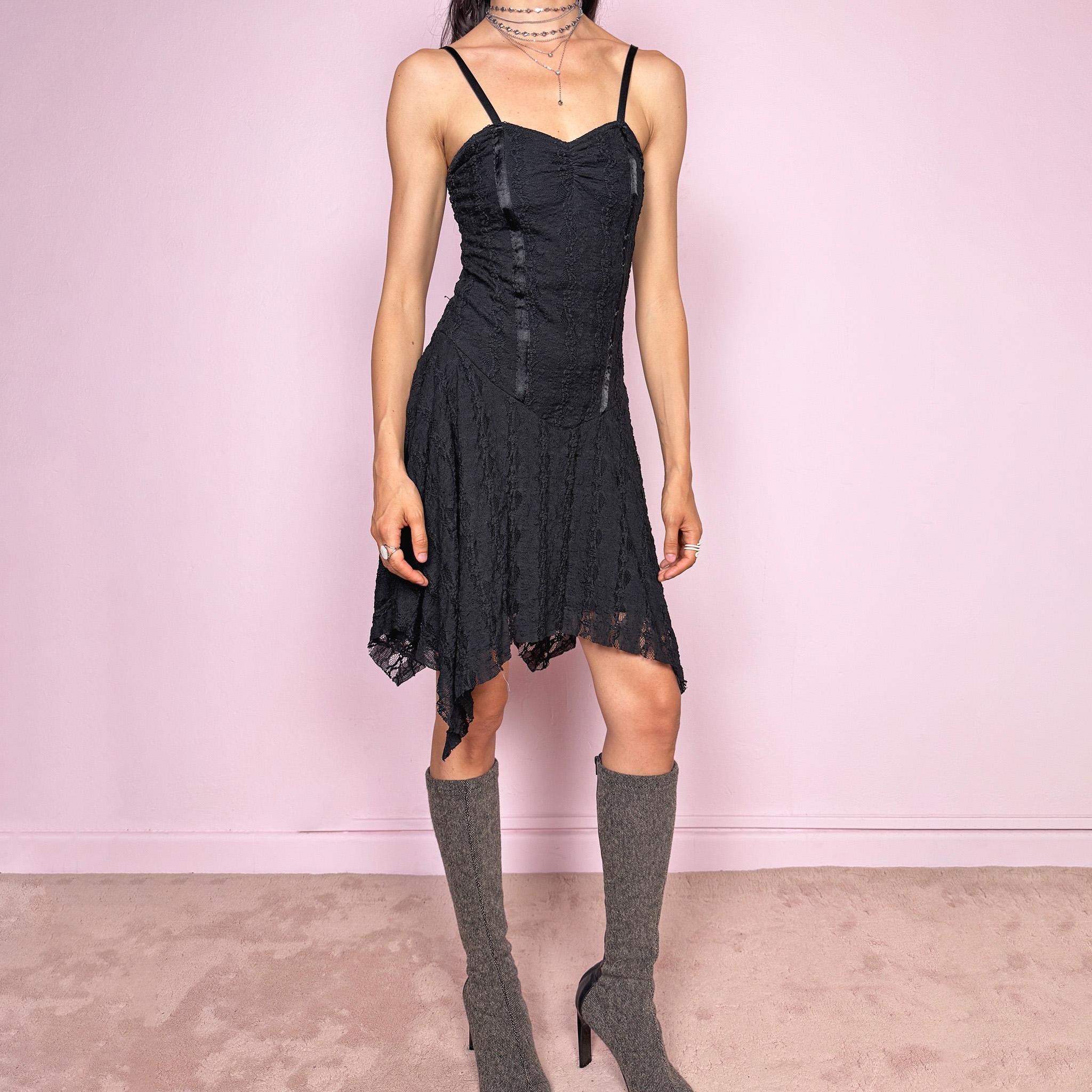 Vintage 2000s whimsical fairy goth black lace midi dress with a fitted body-skimming silhouette and adjustable straps. Features delicate sheer lace texture and an asymmetrical handkerchief hem. Perfect for night parties, festivals or dark romantic styling. Made in the UK from a polyester elastane blend. Great vintage condition.
