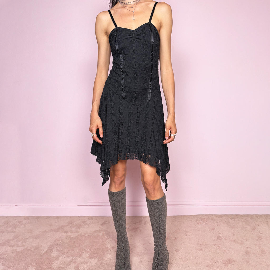 Vintage 2000s whimsical fairy goth black lace midi dress with a fitted body-skimming silhouette and adjustable straps. Features delicate sheer lace texture and an asymmetrical handkerchief hem. Perfect for night parties, festivals or dark romantic styling. Made in the UK from a polyester elastane blend. Great vintage condition.