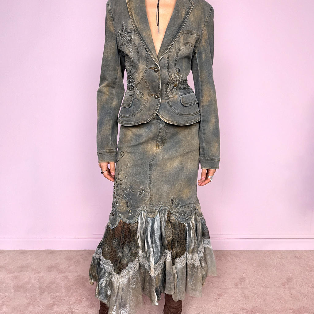 Vintage 2000s green-gray denim set with a faded tie-dye effect, including a tailored blazer-style jacket and matching mid-rise midi skirt. Both pieces are slightly stretchy and embellished with beads and rhinestones. The skirt features a dramatic trumpet ruffle mixed-fabric hem for a striking silhouette. Iconic statement Y2K set. Made from 95% cotton and 5% spandex. Excellent vintage condition.