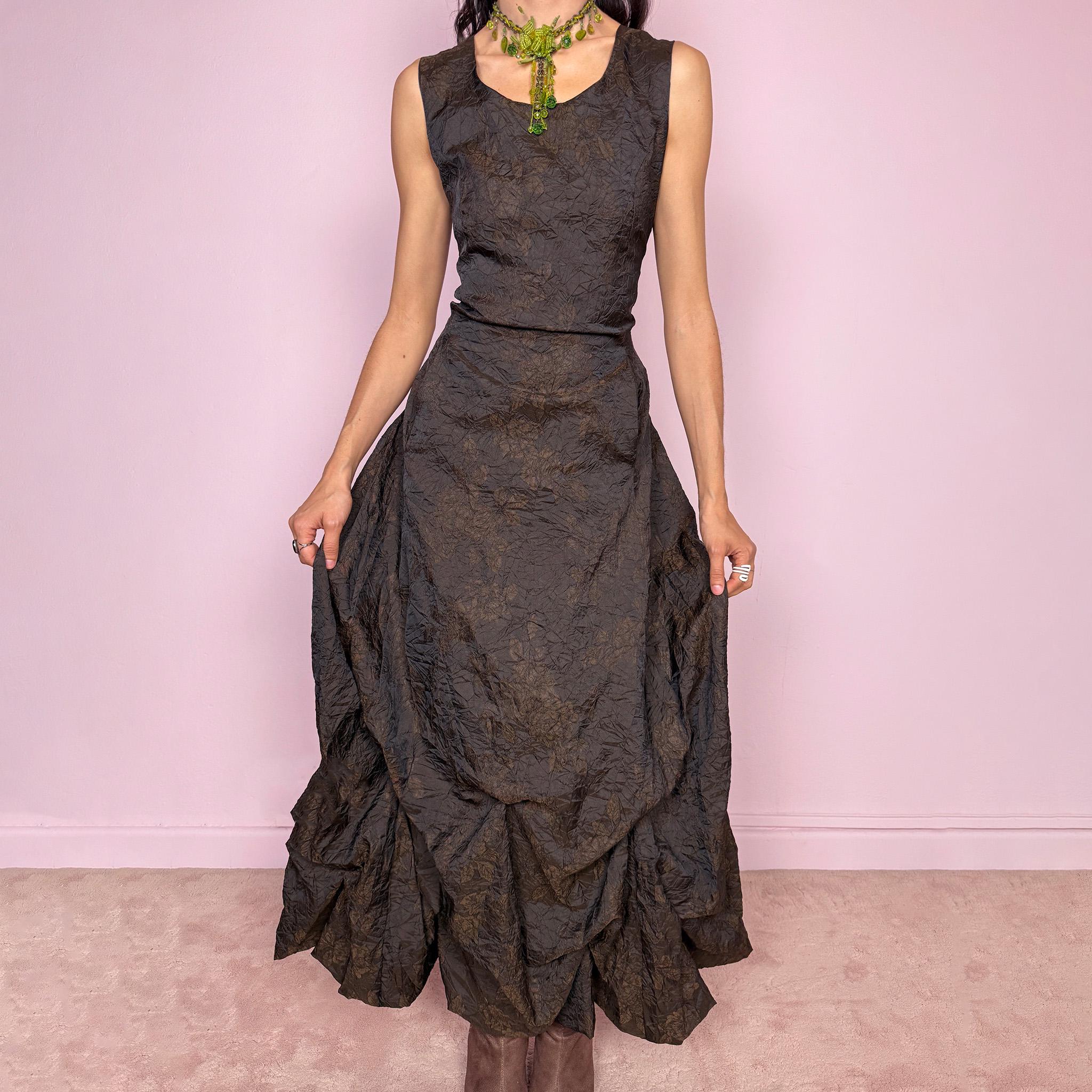 Vintage 90s dark brown sleeveless midi dress with a crinkle texture and subtle floral pattern. Features a voluminous draped balloon bubble hem and lace-up back for a fitted silhouette. Non-stretch design with avant-garde formal elegance, perfect for night events or statement evenings. Made in France from 50% acetate and 50% polyester. Excellent vintage condition.