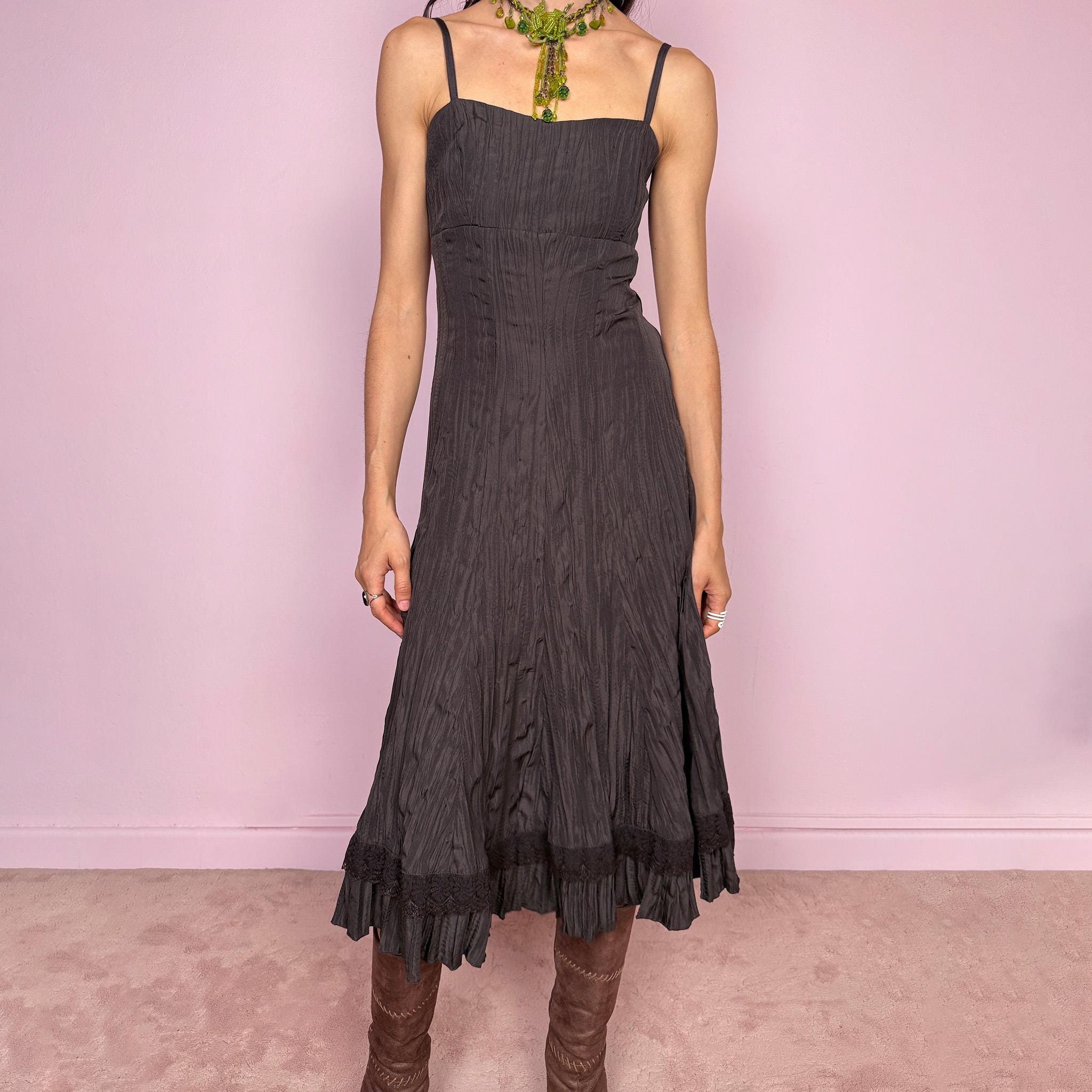 Vintage 2000s dark brown midi dress with a crinkle pleated texture and sleek fitted silhouette. Features adjustable straps, side zip closure, and a soft ruffle hem for fluid movement. Non-stretch design with minimal avant-garde elegance, perfect for formal parties, night events, or dark fairy styling. Excellent vintage condition.