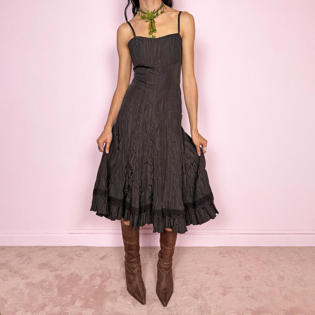 Vintage 2000s dark brown midi dress with a crinkle pleated texture and sleek fitted silhouette. Features adjustable straps, side zip closure, and a soft ruffle hem for fluid movement. Non-stretch design with minimal avant-garde elegance, perfect for formal parties, night events, or dark fairy styling. Excellent vintage condition.