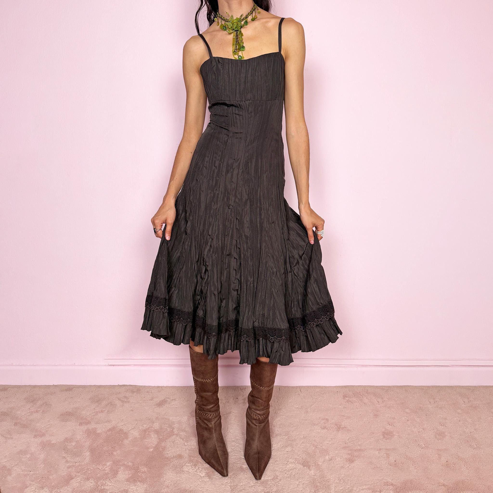 Vintage 2000s dark brown midi dress with a crinkle pleated texture and sleek fitted silhouette. Features adjustable straps, side zip closure, and a soft ruffle hem for fluid movement. Non-stretch design with minimal avant-garde elegance, perfect for formal parties, night events, or dark fairy styling. Excellent vintage condition.