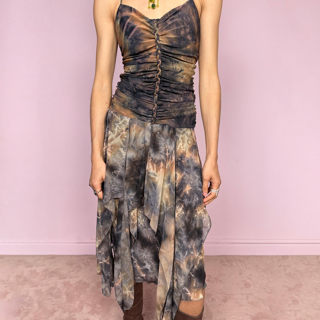 Vintage 2000s multicolored halter midi dress with a tie-neck design and ruched stretchy bodice for a flattering fitted silhouette. Features a dramatic asymmetric handkerchief hem and bold psychedelic tie-dye print in earthy tones. Stunning statement piece perfect for festivals, boho fairy styling, or summer events. Made in USA from polyester. Excellent vintage condition.