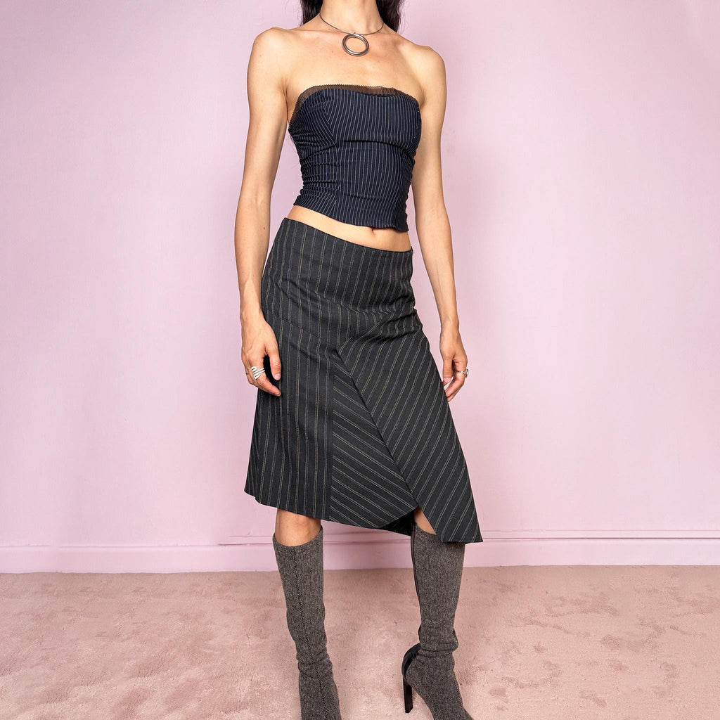 Vintage 2000s dark gray pinstripe midi skirt with a deconstructed avant-garde formal office look. Features an asymmetric layered front, pointed hem, structured no-stretch fit, and side zip closure. Can be worn mid rise for size S or lower rise for size XS. Excellent vintage condition.