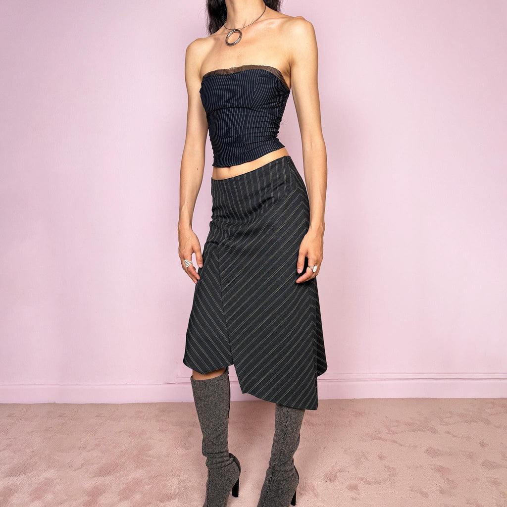 Vintage 2000s dark gray pinstripe midi skirt with a deconstructed avant-garde formal office look. Features an asymmetric layered front, pointed hem, structured no-stretch fit, and side zip closure. Can be worn mid rise for size S or lower rise for size XS. Excellent vintage condition.