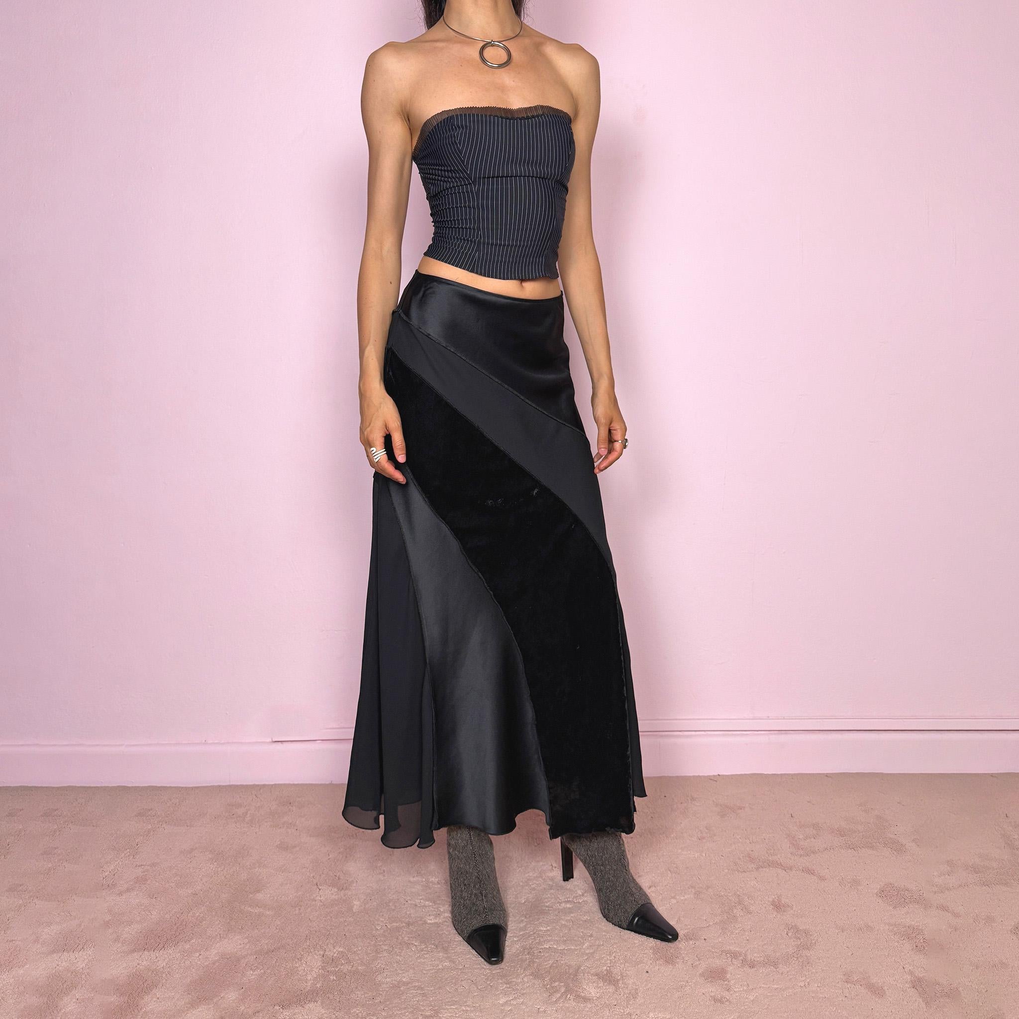 Vintage 2000s black midi skirt with a formal avant-garde minimal look, mixed velvet, satin, and sheer flare panels, asymmetric diagonal construction, side zip closure, and structured no-stretch fit. Elegant statement piece for evening, night, or event styling. Can be worn high waisted for S or lower rise for XS/XXS. Made from polyester. Excellent vintage condition.