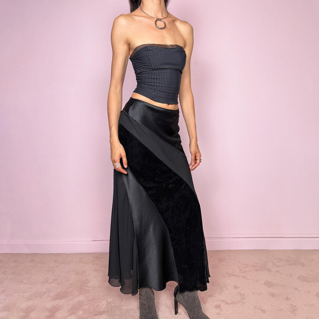 Vintage 2000s black midi skirt with a formal avant-garde minimal look, mixed velvet, satin, and sheer flare panels, asymmetric diagonal construction, side zip closure, and structured no-stretch fit. Elegant statement piece for evening, night, or event styling. Can be worn high waisted for S or lower rise for XS/XXS. Made from polyester. Excellent vintage condition.