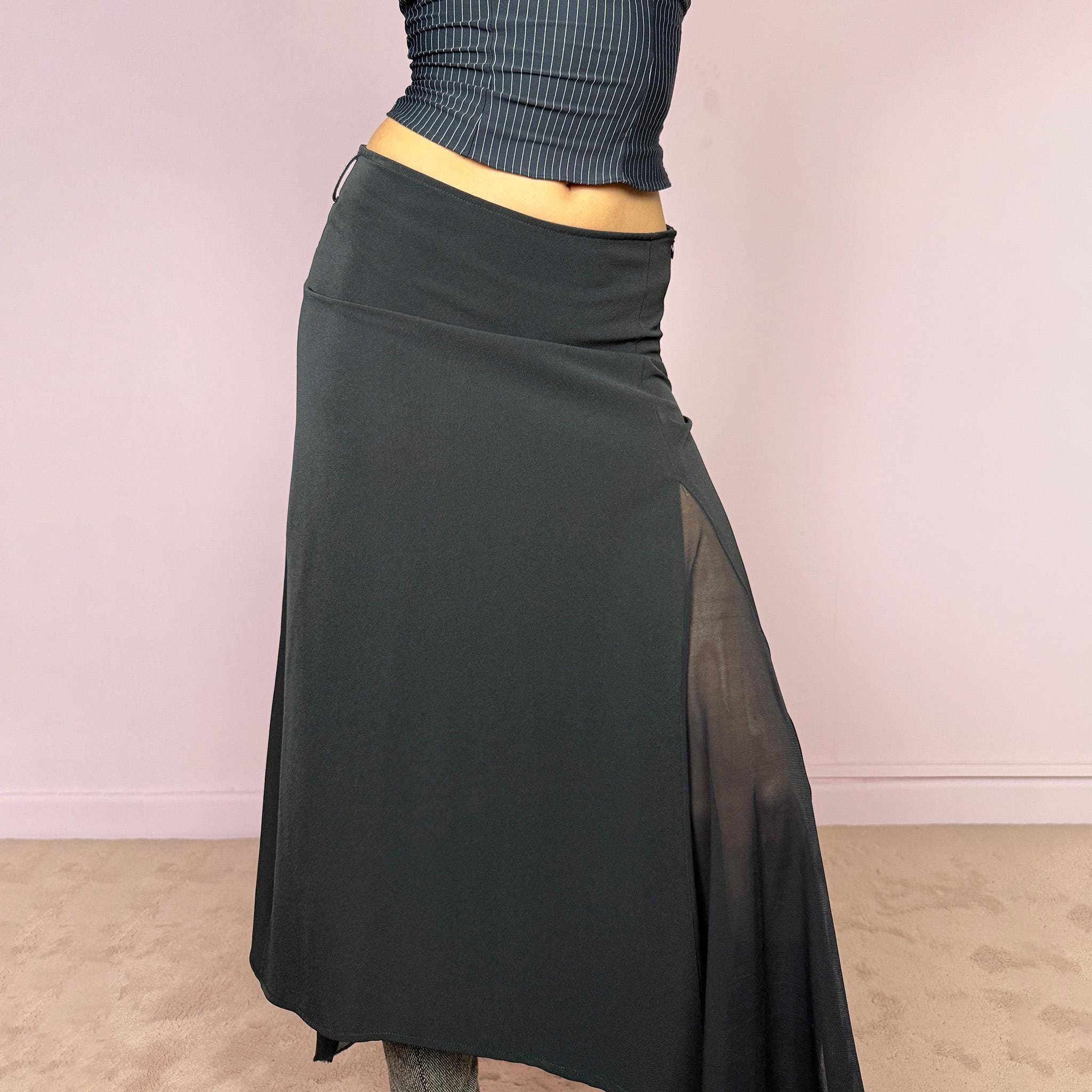 Vintage 2000s black midi skirt with an avant-garde deconstructed look. Features a pointed asymmetric hem, semi-sheer mesh panel detail, side zip closure, and a smooth no-stretch fit with a fluid draped silhouette. Perfect for dark styling and evening events. Can be worn high waisted for S or lower rise for XS/XXS. Made from a polyester elastane blend. Excellent vintage condition.
