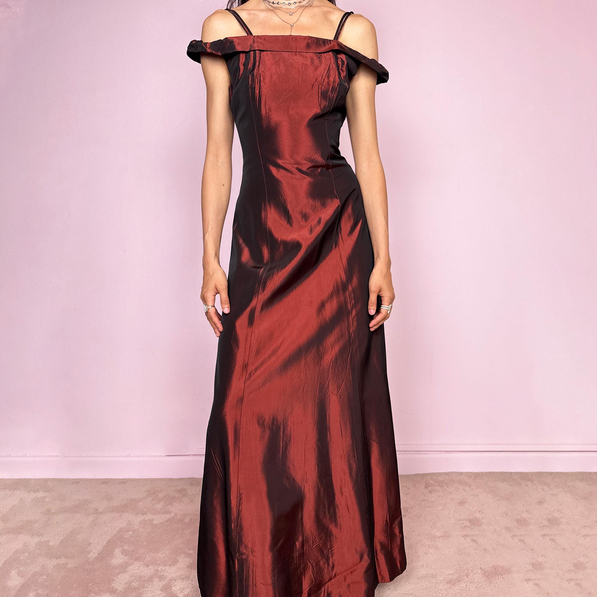 Vintage 2000s statement evening gown in rich burgundy iridescent fabric with a sculpted off shoulder neckline and delicate straps. Elegant body-skimming silhouette with full length maxi cut, subtle flare hem and back zip closure. Dramatic old Hollywood energy, perfect for formal events, editorials or modern occasionwear. Non-stretch fabric. Excellent vintage condition.