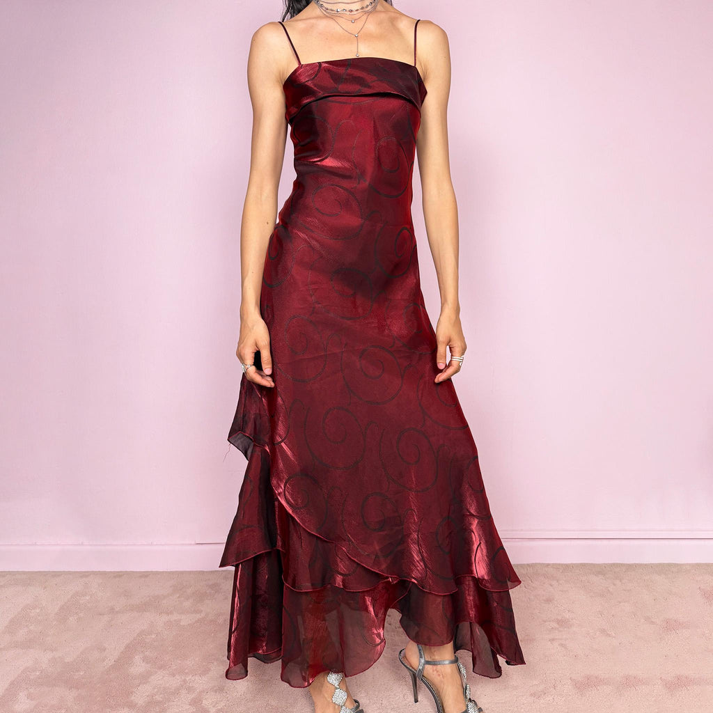 Vintage 2000s statement burgundy midi dress with iridescent shimmer and elegant layered construction. Features spaghetti straps, asymmetrical tiered hem and sheer overlay with swirl pattern. Fluid body-skimming fit with romantic movement, perfect for evening events or occasionwear. Made in France from a polyester elastane blend. Excellent vintage condition.