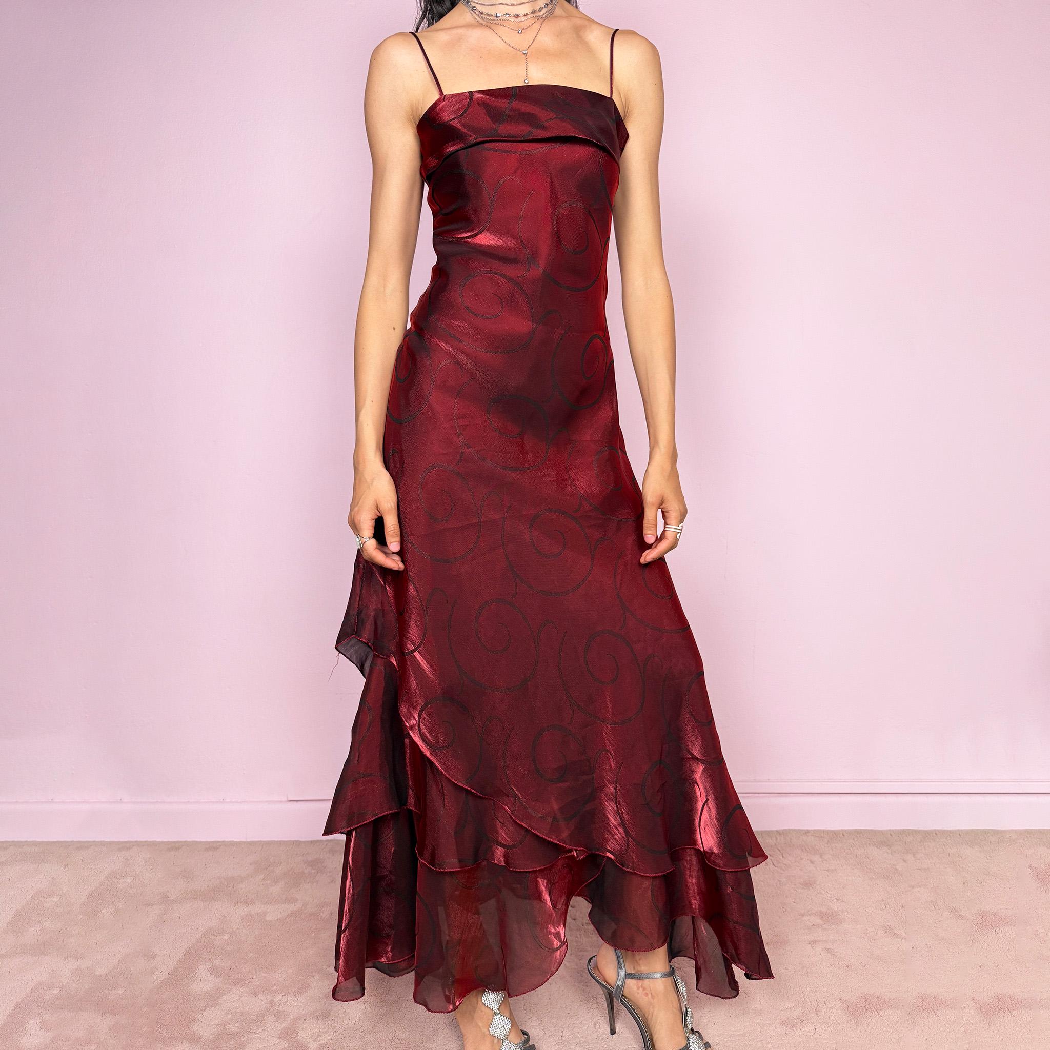 Vintage 2000s statement burgundy midi dress with iridescent shimmer and elegant layered construction. Features spaghetti straps, asymmetrical tiered hem and sheer overlay with swirl pattern. Fluid body-skimming fit with romantic movement, perfect for evening events or occasionwear. Made in France from a polyester elastane blend. Excellent vintage condition.
