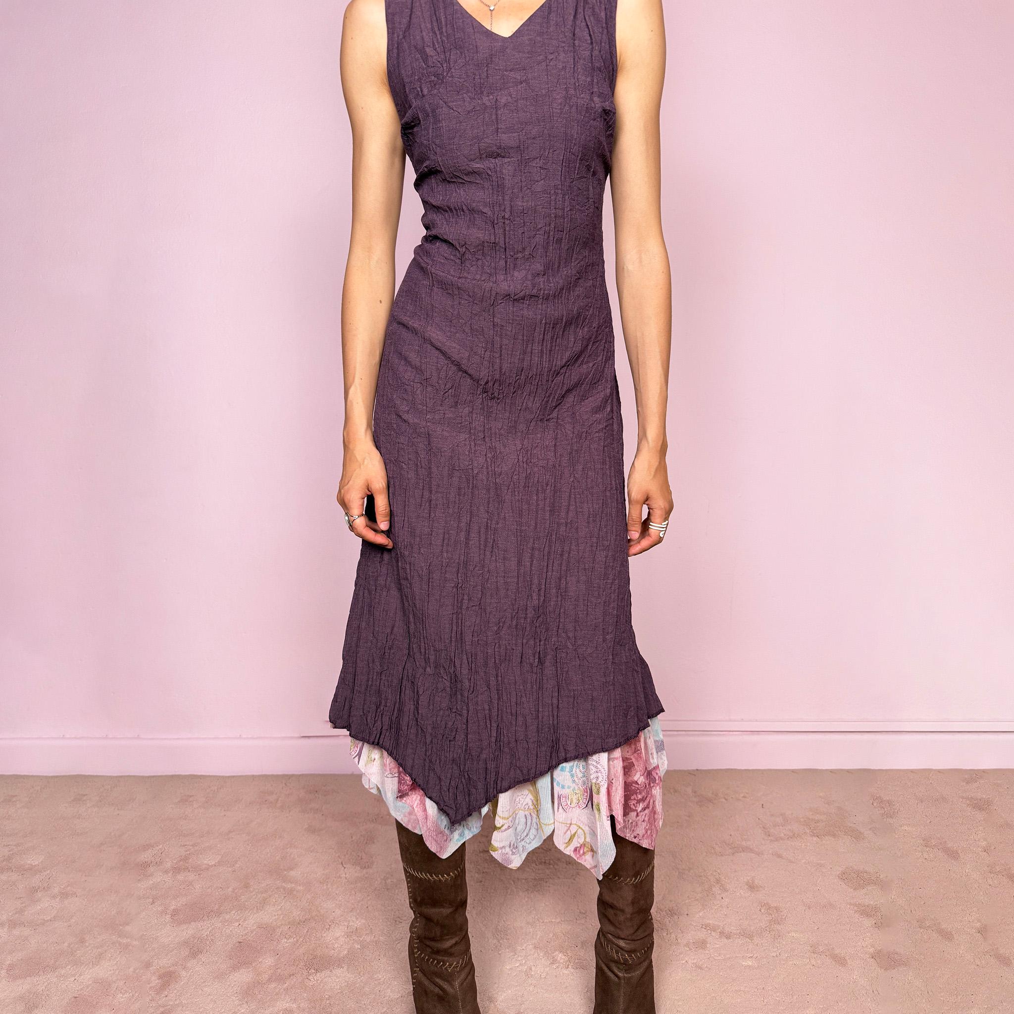 Vintage 2000s purple sleeveless midi dress with a minimal avant-garde look, no stretch, V-neckline, crinkle texture, flowy fit, side zip closure, and an asymmetric hem with graphic print mesh ruffle detail. Made by a French brand from a polyester viscose blend. Great vintage condition.