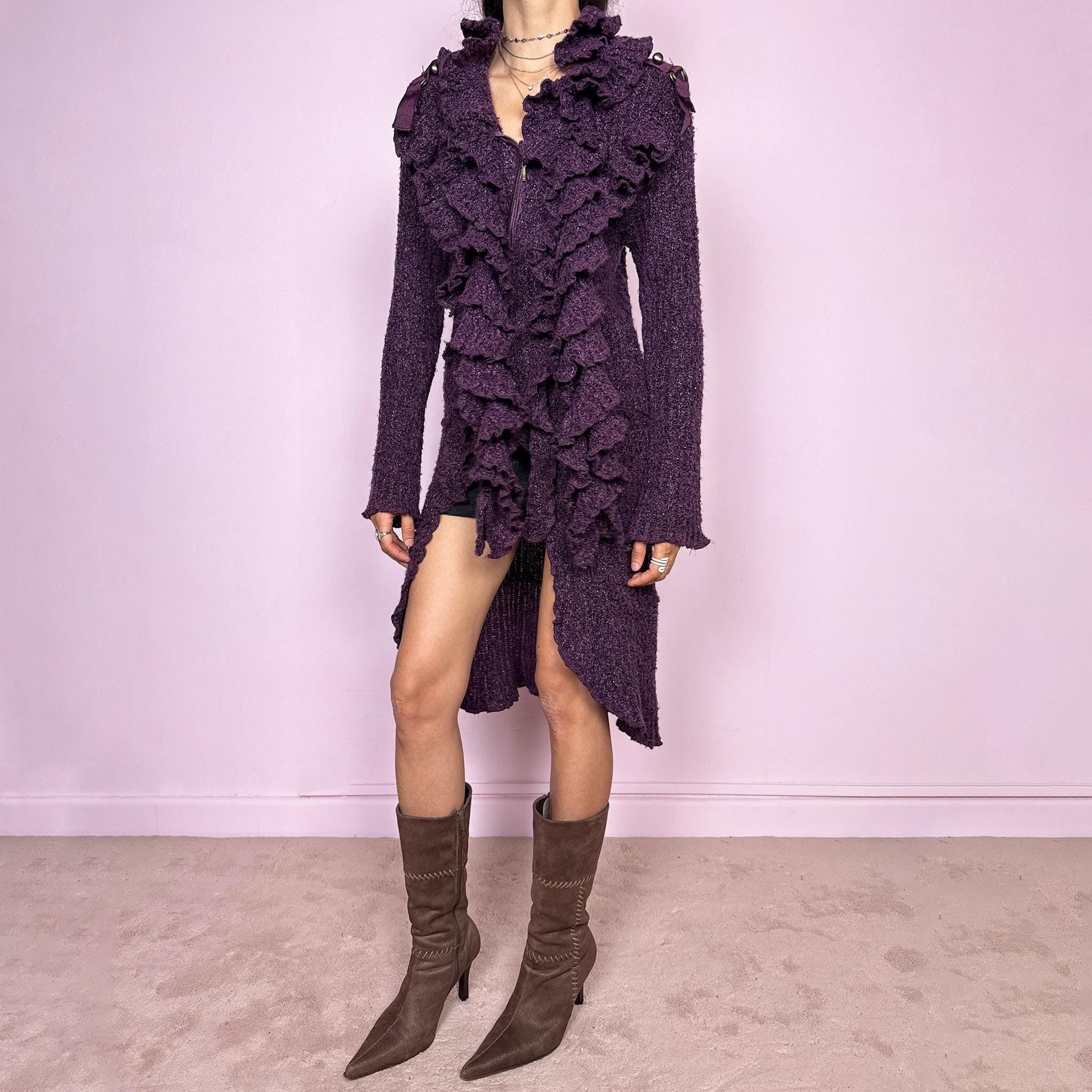 Vintage 2000s purple and black longline crazy cardigan with metallic thread, a zip-front closure, long bell sleeves, sculptural ruffle neckline, 3D cascading front ruffles, and an asymmetric high-low hem. Dramatic, extravagant, and bold for winter. Made by a French brand from an acrylic polyester blend. Great vintage condition.