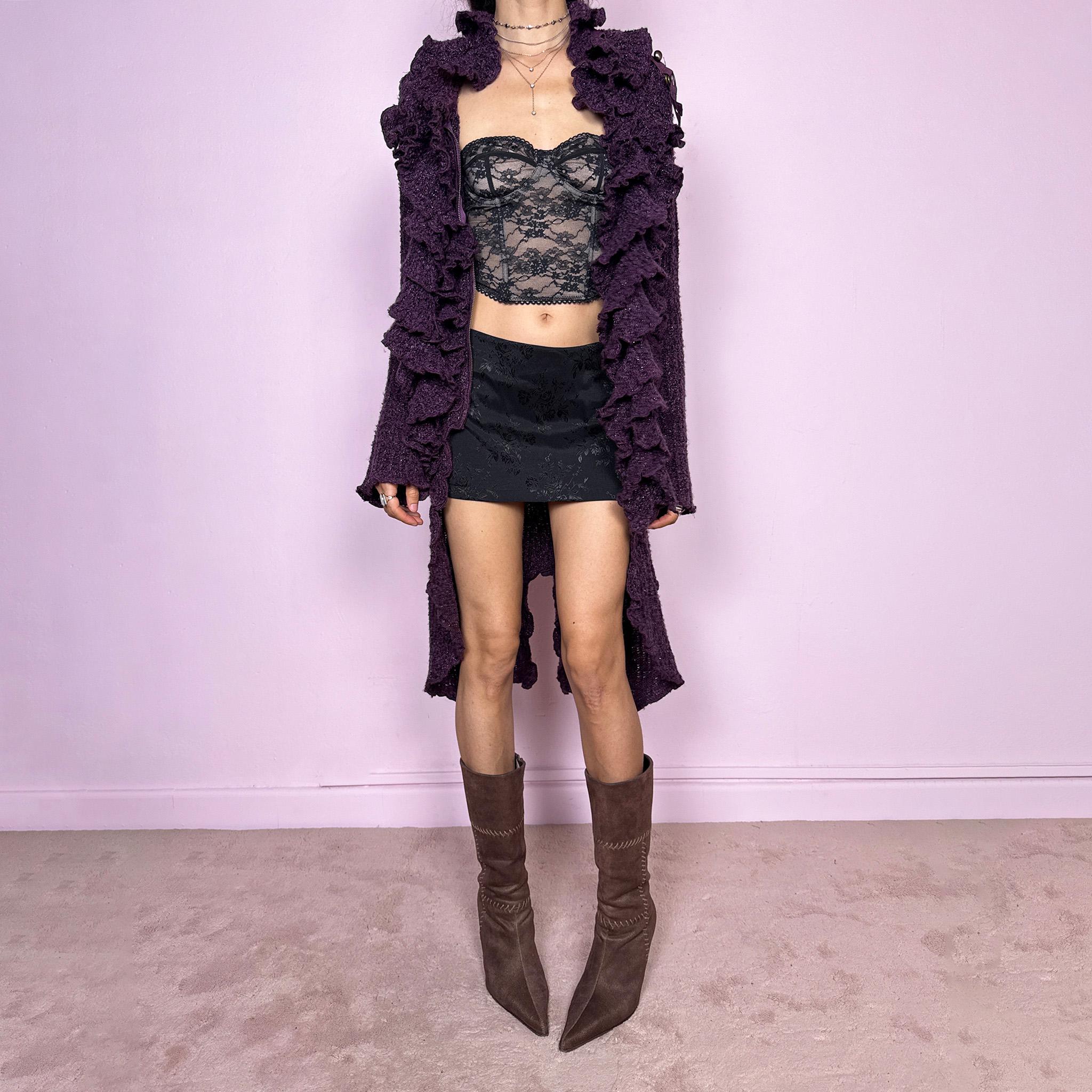 Vintage 2000s purple and black longline crazy cardigan with metallic thread, a zip-front closure, long bell sleeves, sculptural ruffle neckline, 3D cascading front ruffles, and an asymmetric high-low hem. Dramatic, extravagant, and bold for winter. Made by a French brand from an acrylic polyester blend. Great vintage condition.