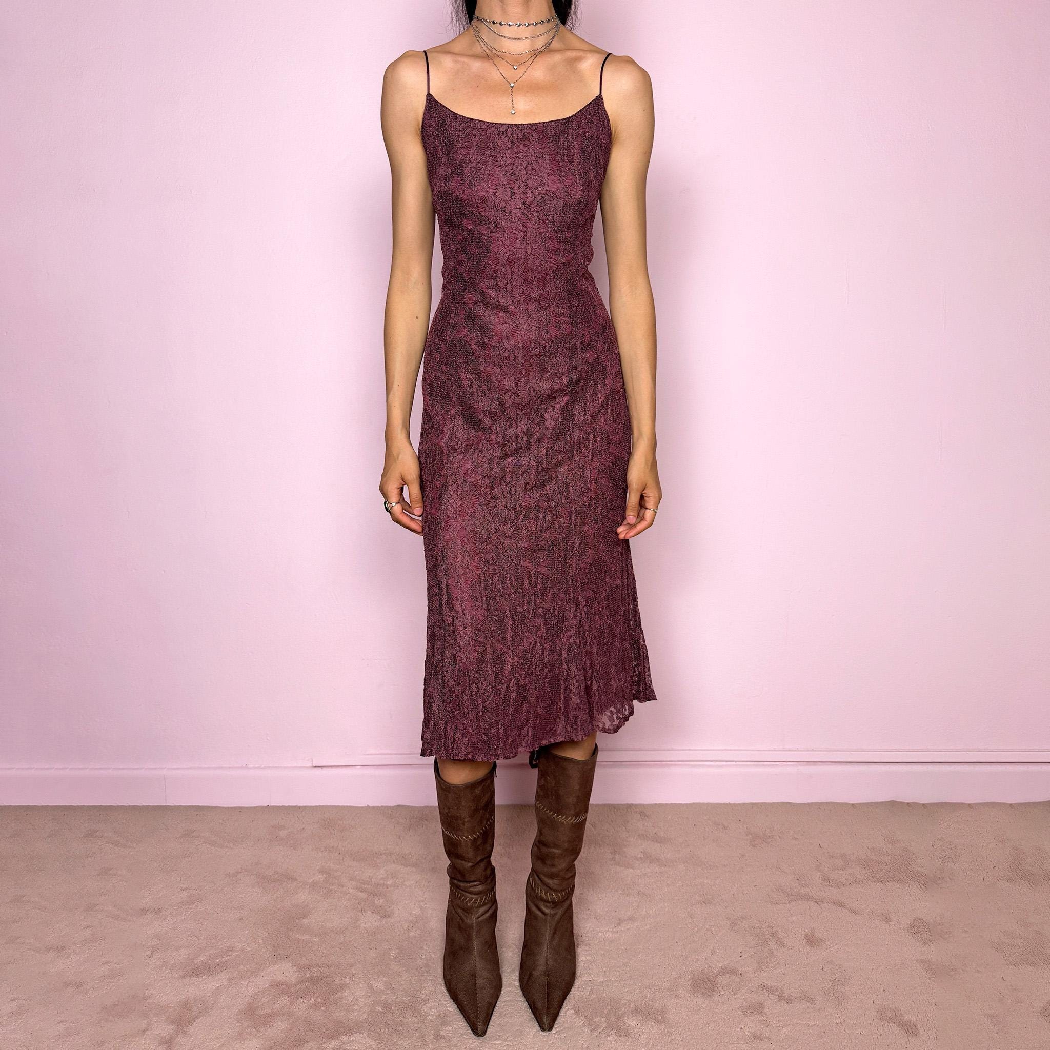 Vintage 2000s burgundy-purple midi slip dress featuring thin straps, a fitted body-skimming silhouette, and a lace overlay. Designed with a back zip closure, no stretch, and a slightly longer hem at the back for a soft, elegant drape. Made with a viscose-polyamide outer layer and polyester lining. A romantic minimal statement Y2K dress, perfect as an elevated evening piece. Excellent vintage condition.