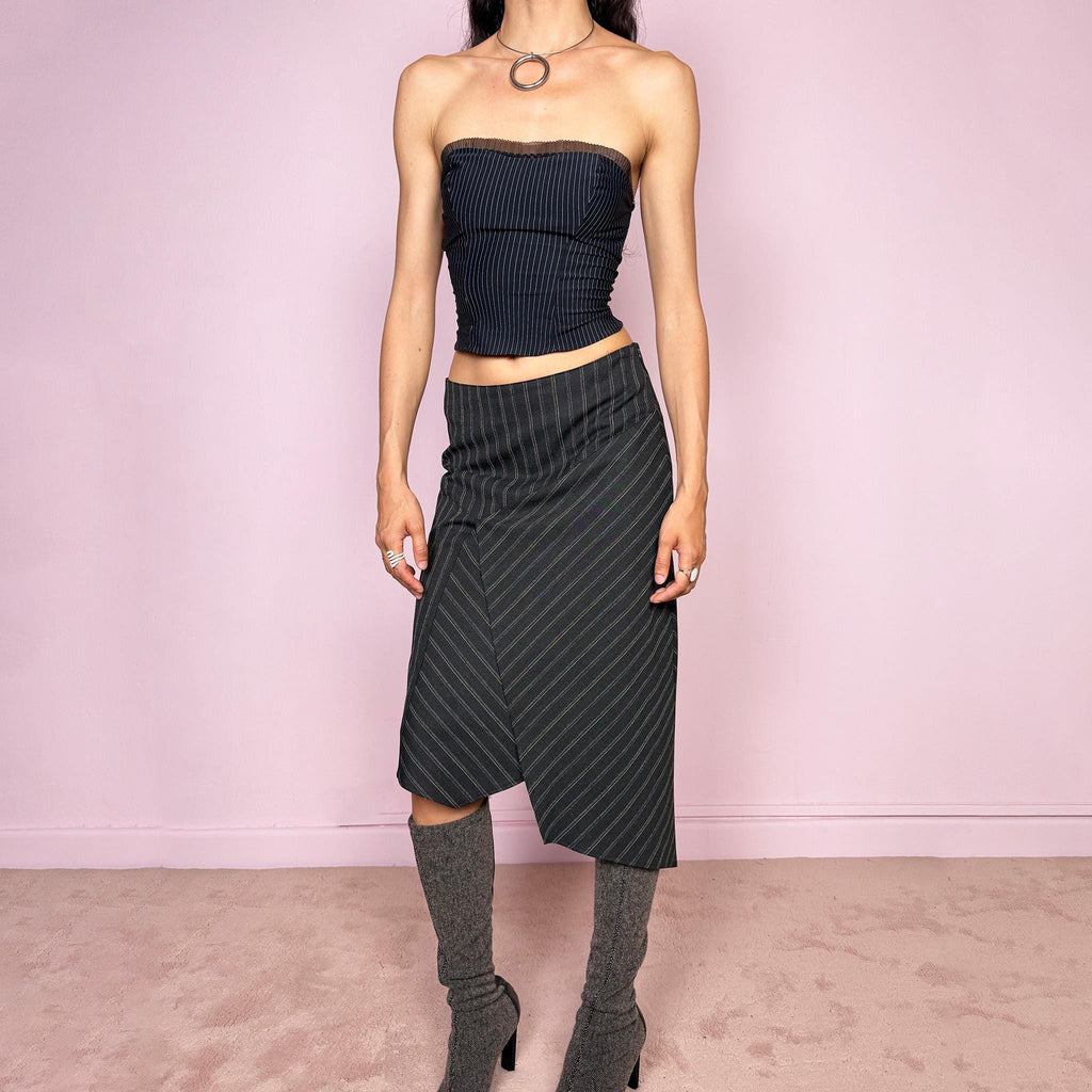 Vintage 2000s dark gray pinstripe midi skirt with a deconstructed avant-garde formal office look. Features an asymmetric layered front, pointed hem, structured no-stretch fit, and side zip closure. Can be worn mid rise for size S or lower rise for size XS. Excellent vintage condition.